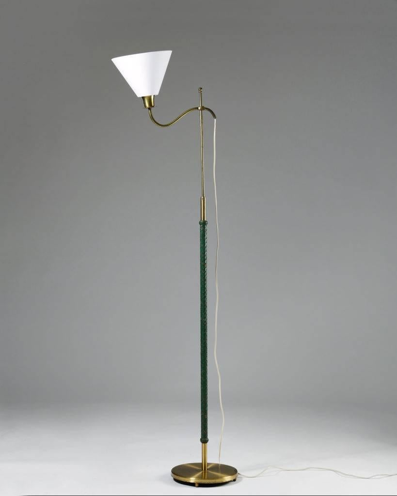 Floor lamp, anonymous,
Sweden, 1950s.

Brass and leather.

Measurements:
H: 185 cm/ 6' 1 1/4