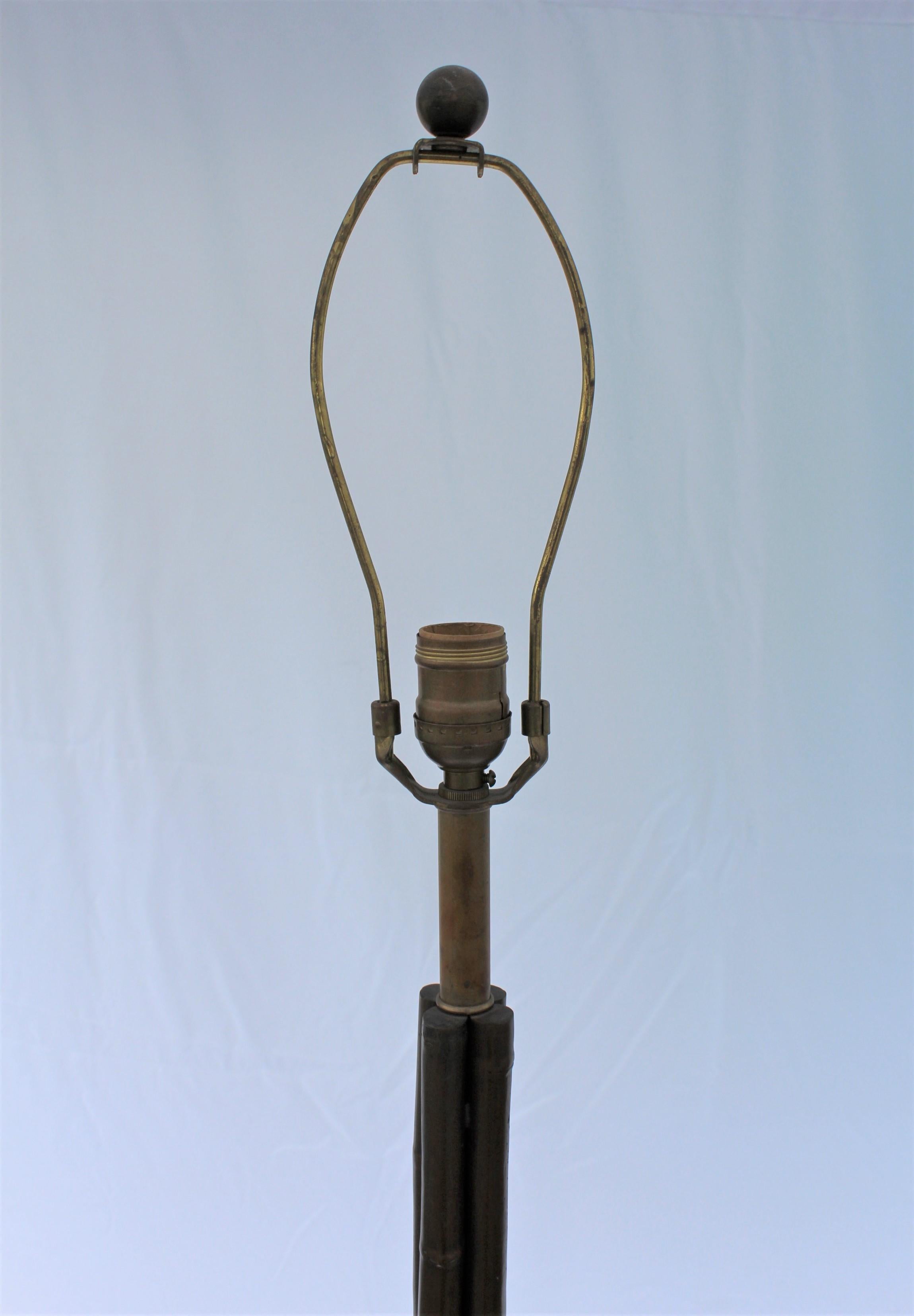 A four legged bronze bamboo design floor lamp. Has a single Edison socket and harp. Also with 4 ball feet pads. Good bronze acid patina. Measures: 69