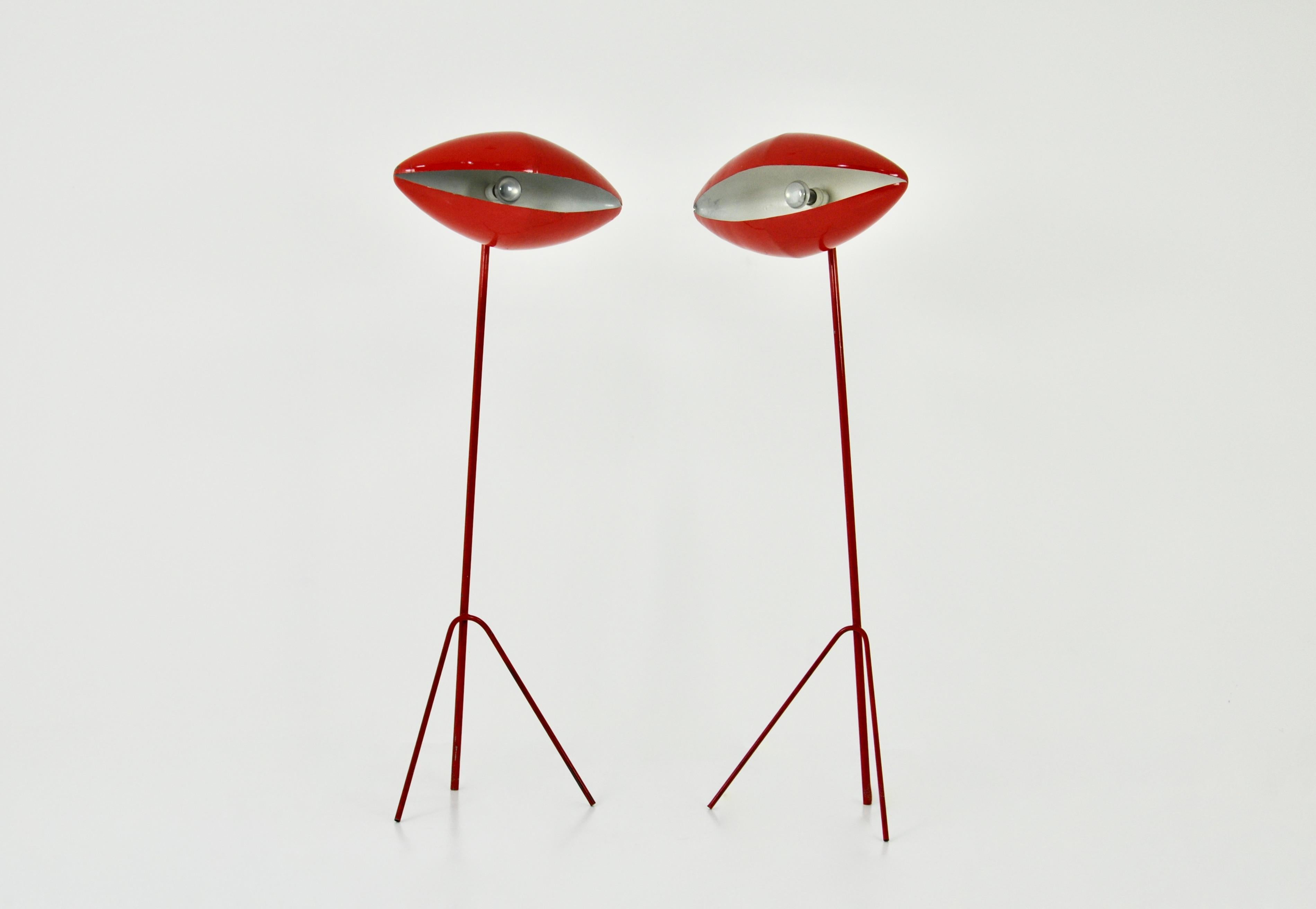 2 Red metal floor lamps by India Mahdavi. Wear due to time and age of the floor lamp.