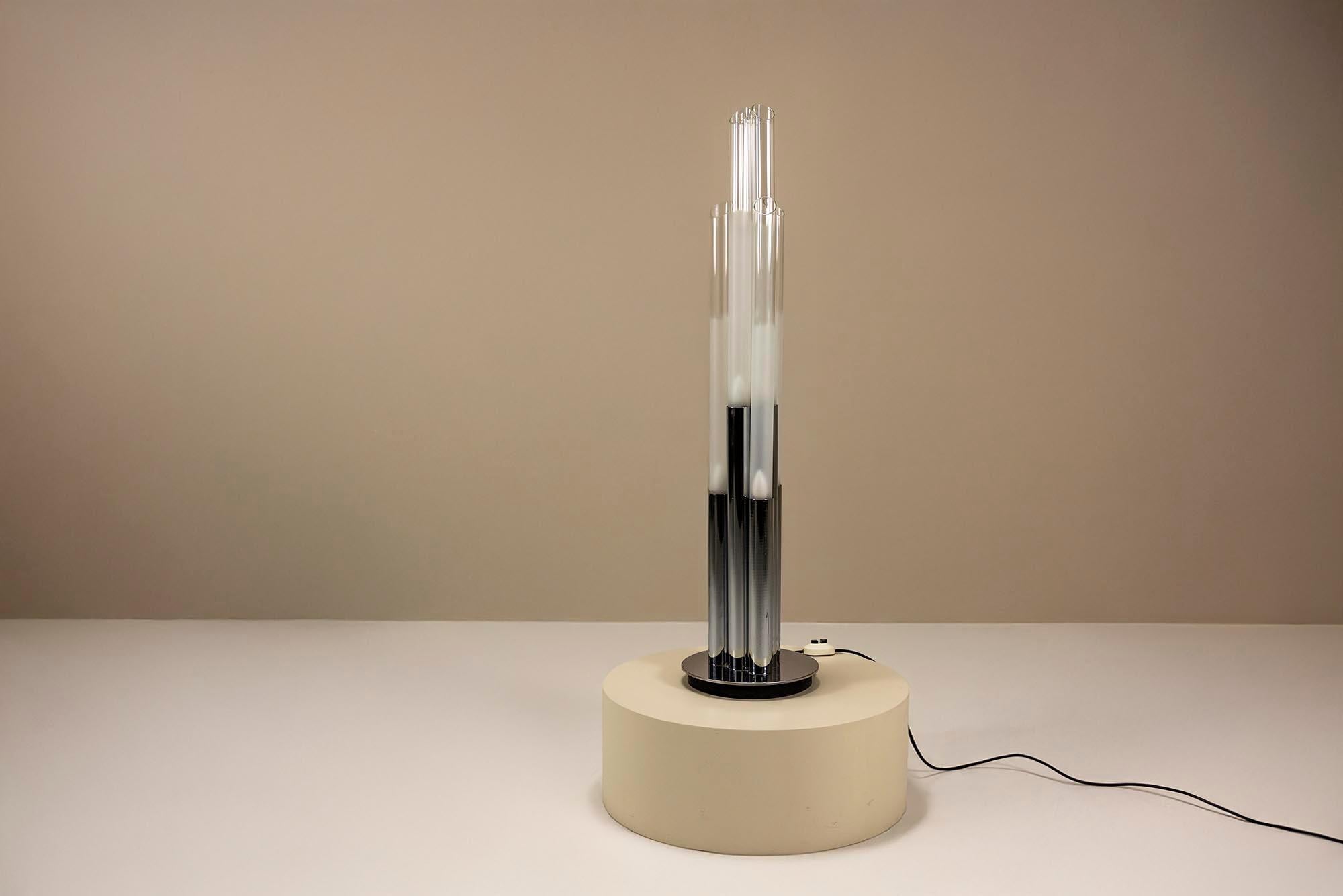 Cette lampe tubulaire sculpturale d'Aldo Nason pour Mazzega offre une vision claire du design d'éclairage de l'ère italienne des années 1970. Cette pièce allie la précision technique à la fluidité artistique.

Design
Six hauts tubes de verre