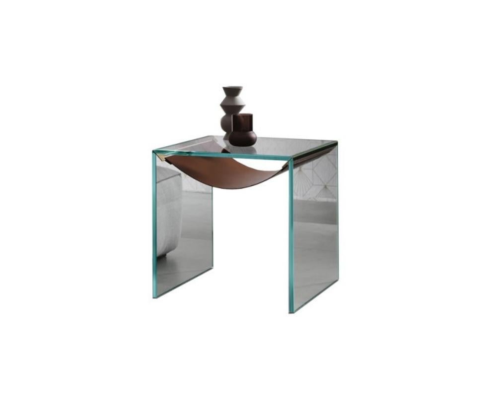 Side table with frame in extra clear glass.
The shelf in leather is held by metal supports (stainless steel) distinguishes and completes the product.

Dimensions
19.6