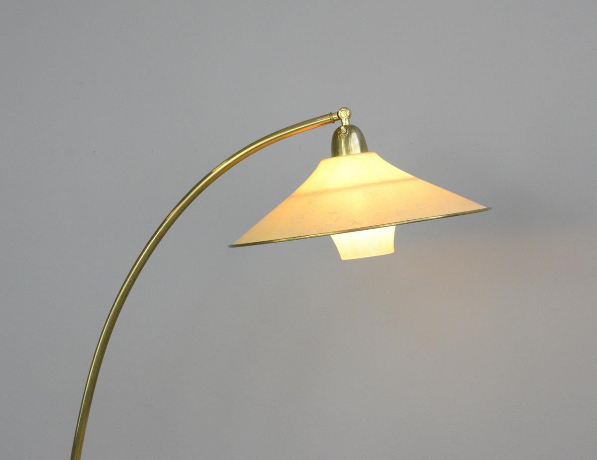 Floor standing brass reading lamp by AEG, circa 1940s

- Curved brass arm
- Translucent Velum 2 part shade
- Takes E27 fitting bulbs
- On/Off switch on the head 
- Made by AEG
- German, late 1940s
- Measures: 120cm tall x 50cm wide x 80cm