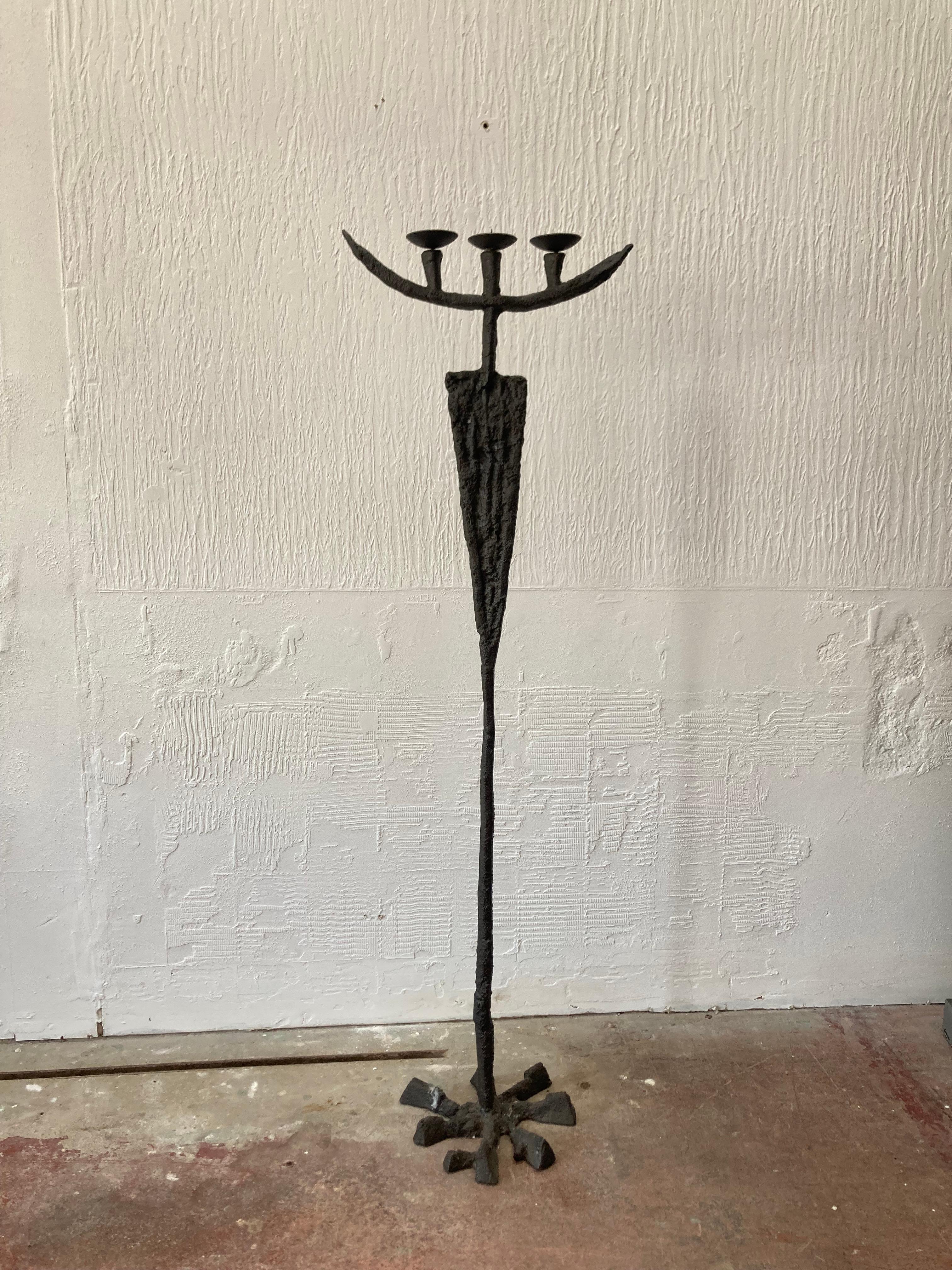 This is a stunning Brutalist candle stand, floor standing. The heavy iron framework supports a wonderful gnarled bronzed finish. It has a tall and strong Brutalist presence.
This is clearly artist made, you can really feel the connection between the