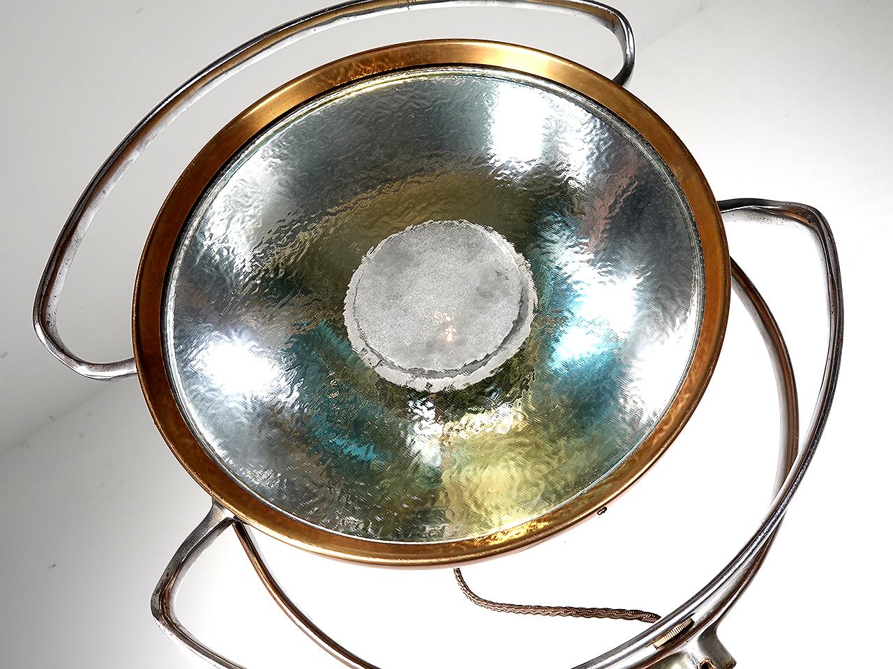 This rare vintage medical C. 1930'S operating room castle light with original heat tempered glass lens. We mounted the fixture to an early wooden camera stand and brass pole to make this a very unique one-of-a-kind floor lamp.
Completely intact and
