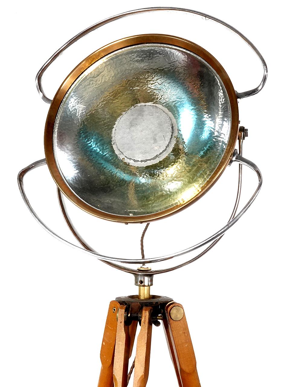 This rare vintage medical C. 1930'S operating room castle light with original heat tempered glass lens. We mounted the fixture to an early wooden tripod stand to make this a very unique one-of-a-kind floor lamp.
Completely intact and rewired c.