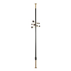 Floor-to-ceiling coat rack in lacquered metal and brass. Contemporary.