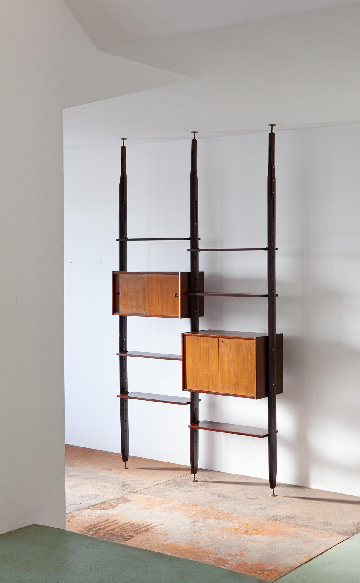 1950s Italian floor to ceiling wall unit

This modern design bookshelf is full of technical details and workmanship typical of high-level Italian manufacturing of the midcentury.
Can also be used as a room divider, as the back is well finished as