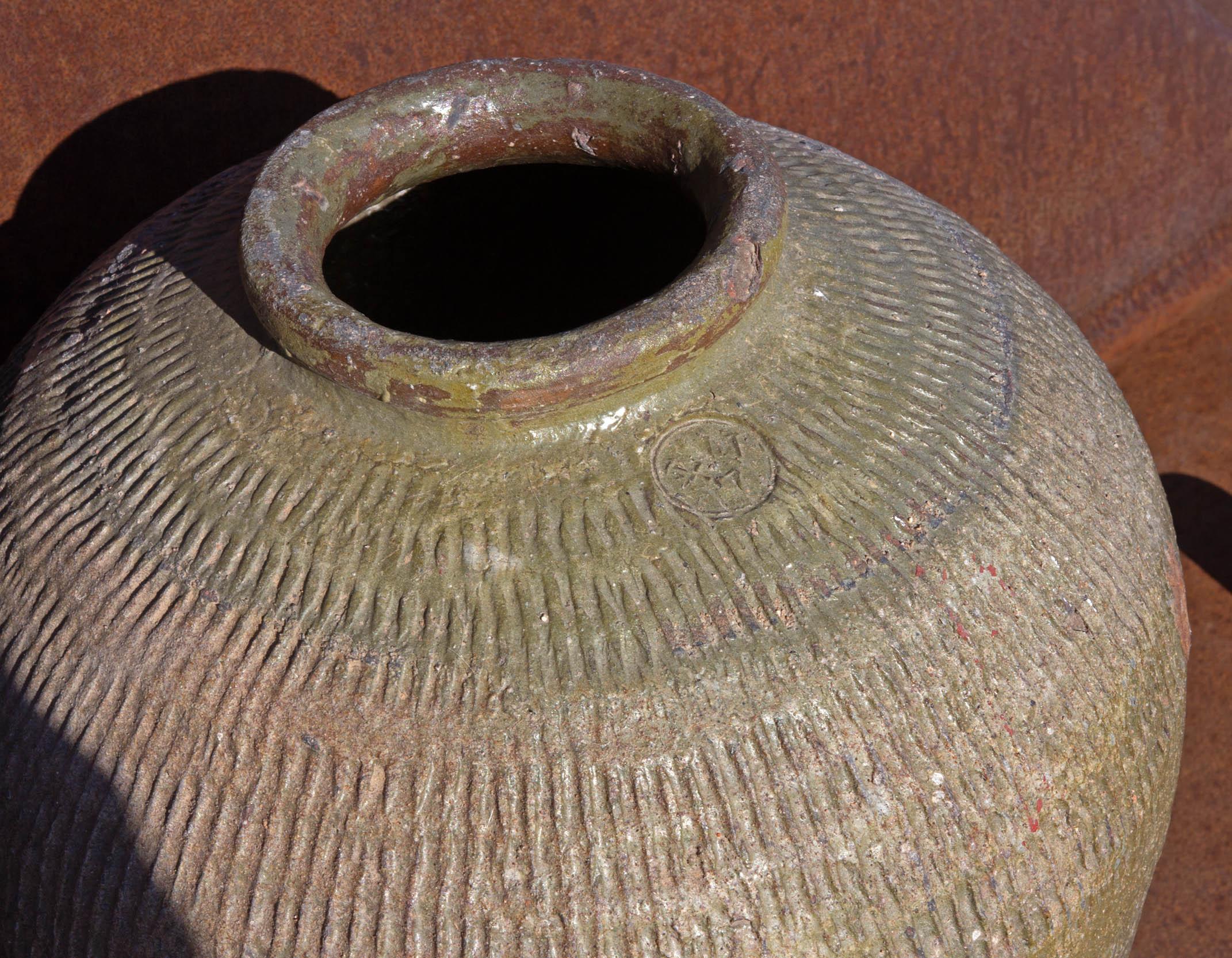 Glazed terracotta rice wine storage jar, China, early 20th century.