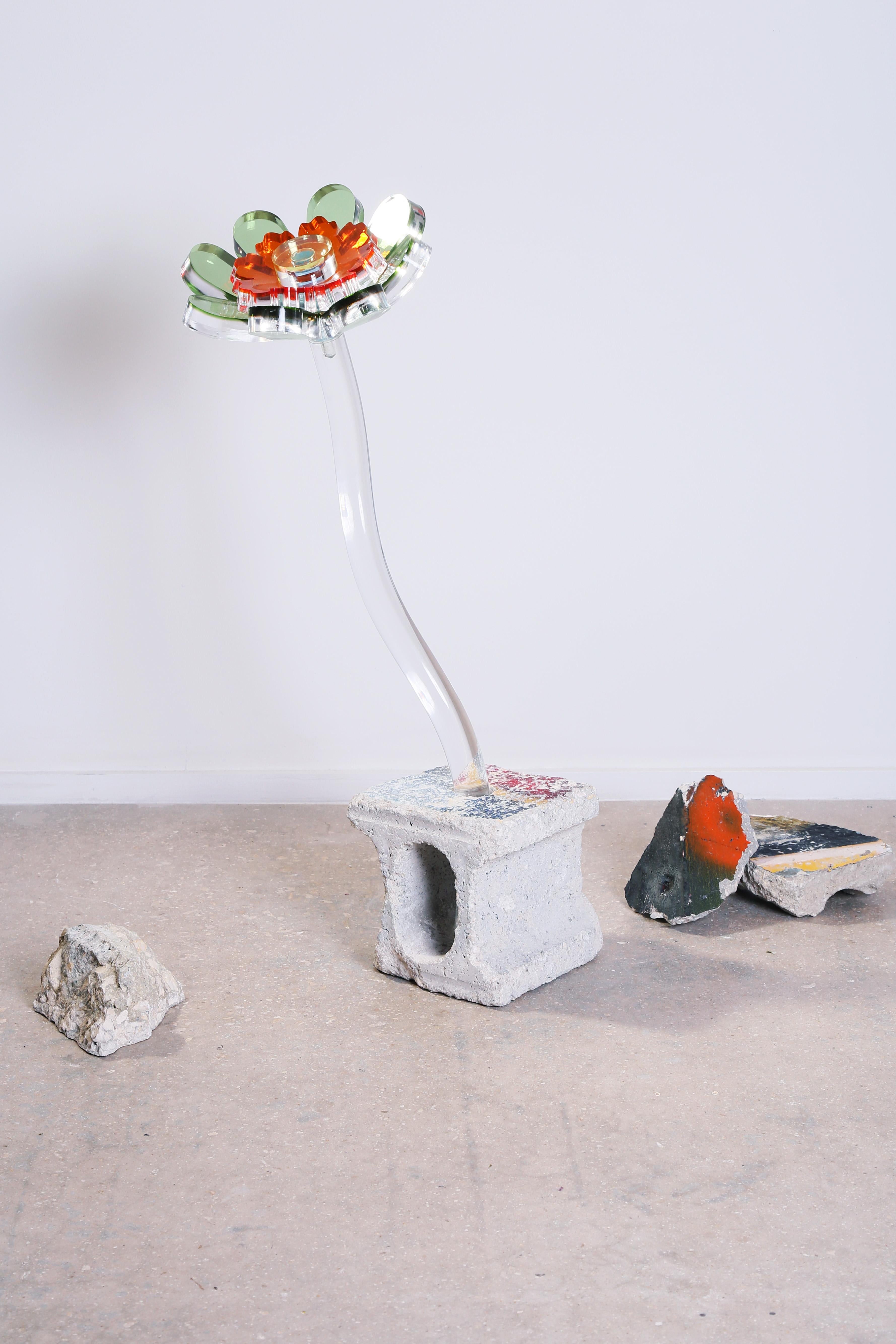 The Flora sculptures are part of the Fossils series. Oversized acrylic flower sculptures are combined with repurposed painted concrete rubble from demolished buildings, allowing the artist to pay tribute to the past, while looking to the future. In