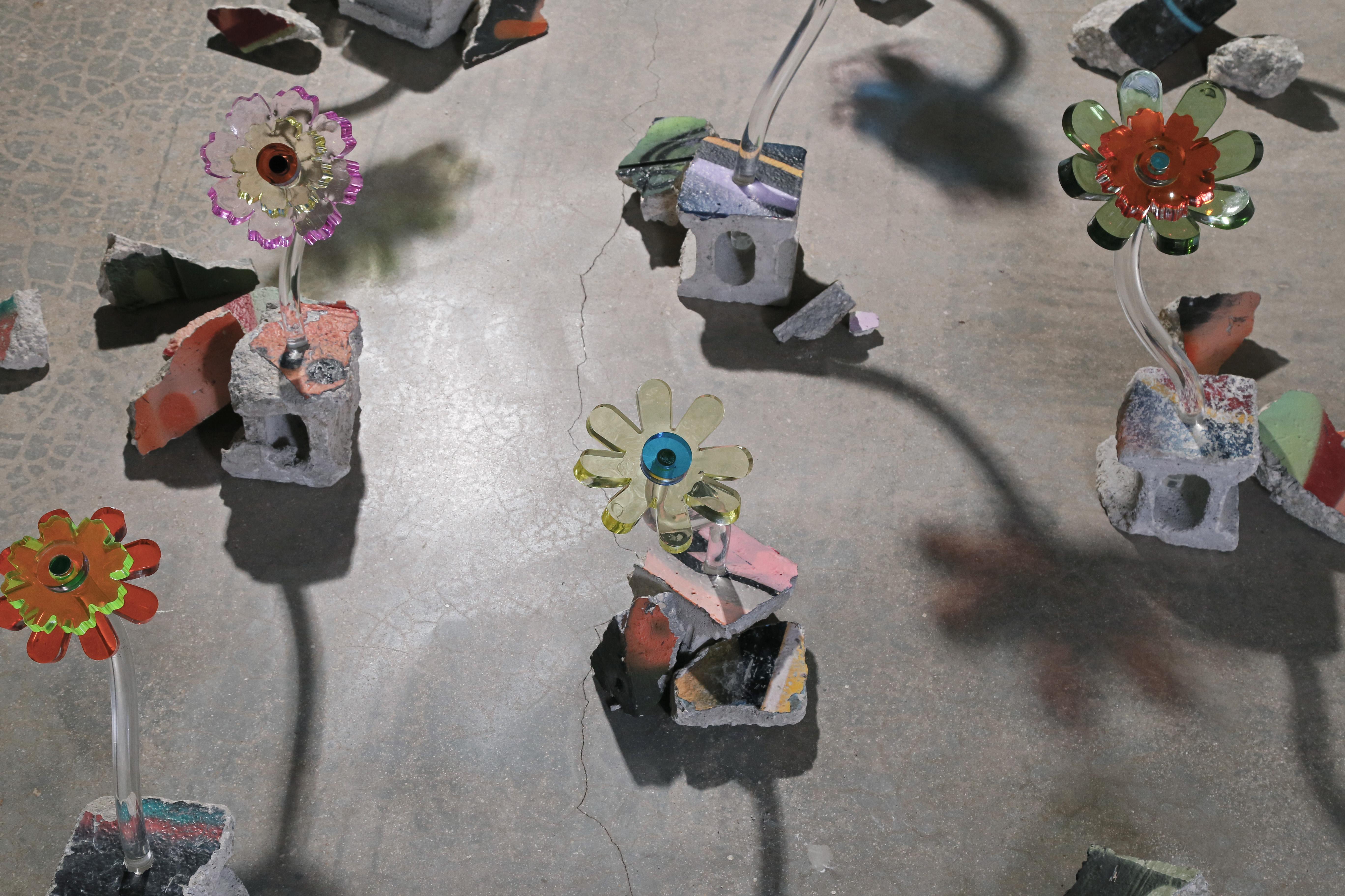 The Flora sculptures are part of the Fossils series. Oversized acrylic flower sculptures are combined with repurposed painted concrete rubble from demolished buildings, allowing the artist to pay tribute to the past, while looking to the future. In