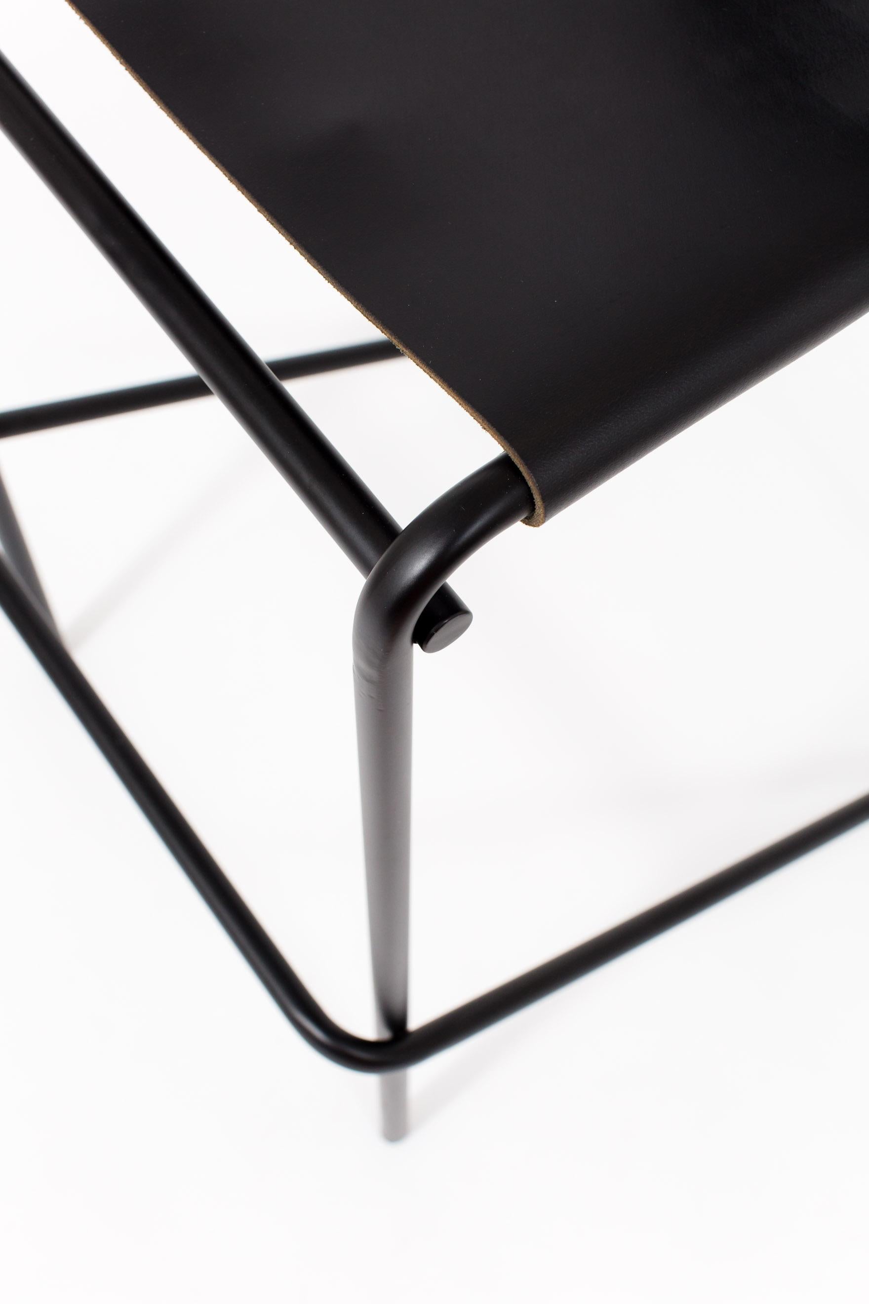 The flora bar stool is composed of just three pieces of steel: an L-shaped back piece that touches the floor and rises up again at an angle to create a foot rest; a rectilinear seat and front support; and a simple, stabilizing cross-bar across the