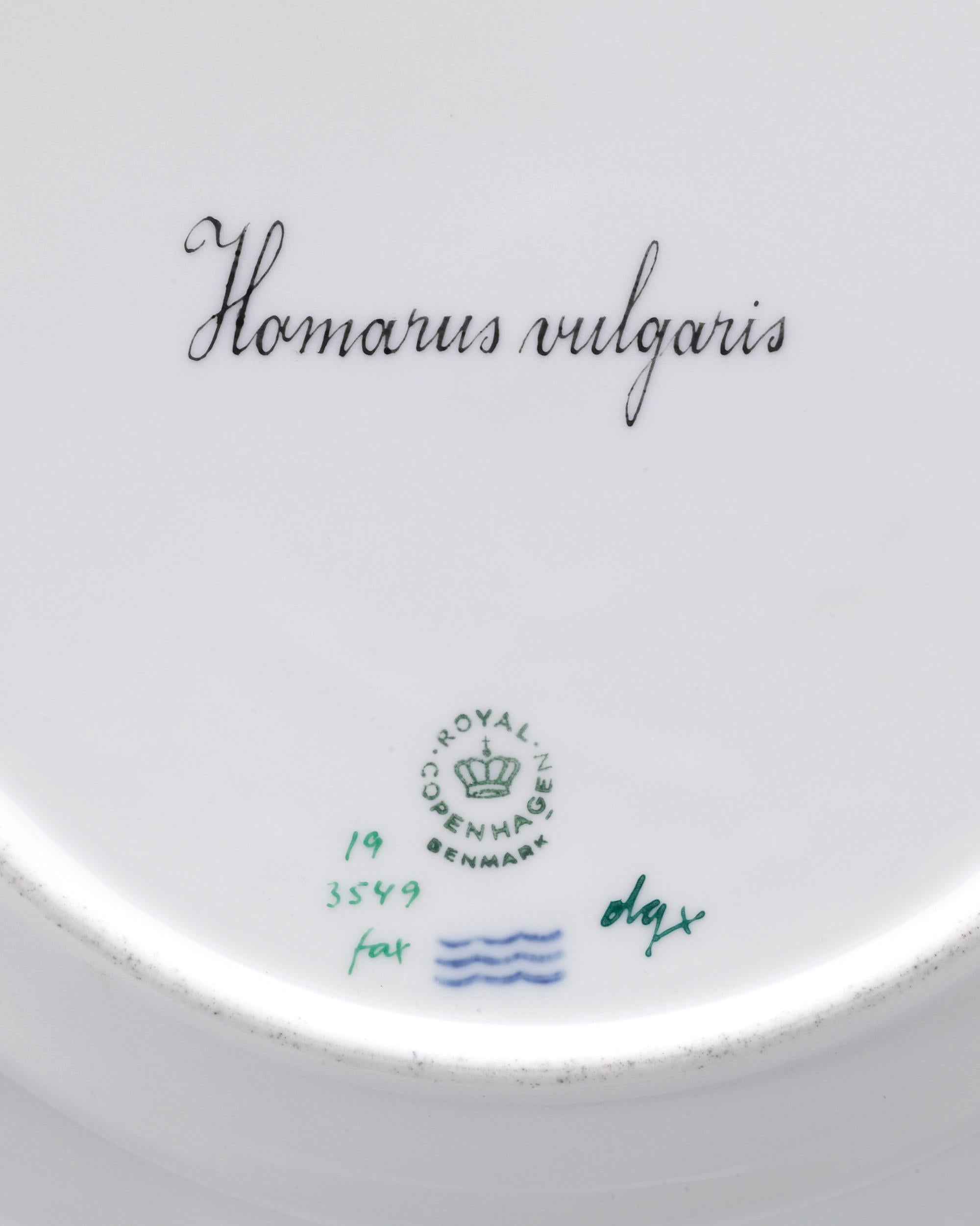 This hand-painted porcelain plate by Royal Copenhagen is crafted in the firm's highly celebrated Flora Danica pattern. Unlike the majority of Flora Danica, which features the native flora of Denmark, this plate is part of a very rare series painted