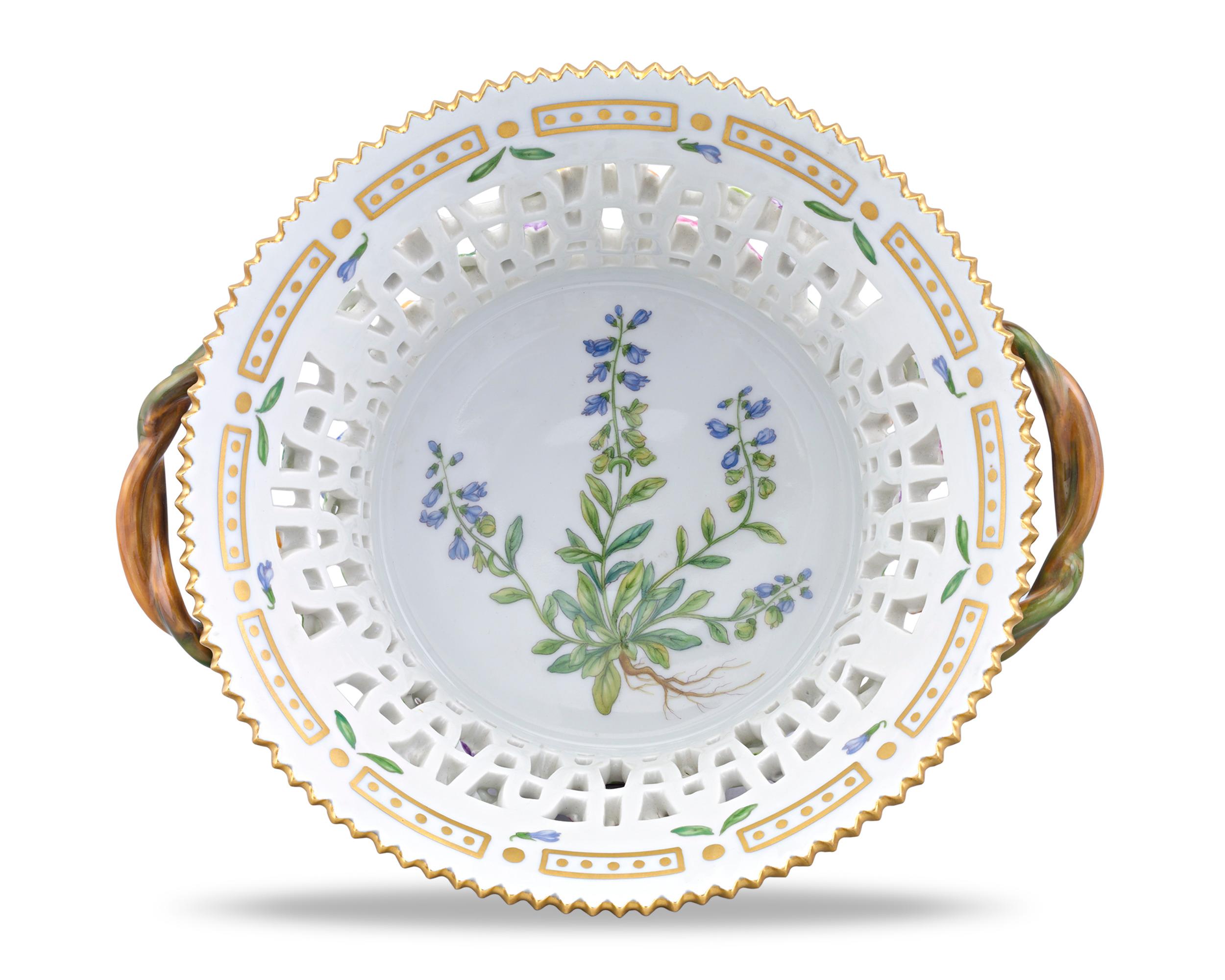 A delicate floral motif encases this rare pierced porcelain basket by the celebrated Royal Copenhagen. Crafted in the highly celebrated Flora Danica motif, the service dish features the Polygala Amarum, or bitter milkwort, depicted with