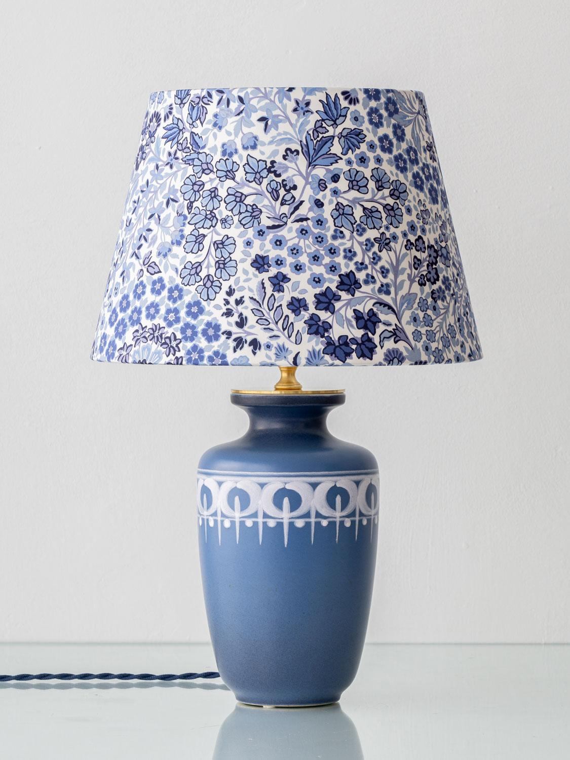 Lovingly handcrafted by Amitābha Studio in Amsterdam, this one-of-a-kind table lamp unites two rare design legacies from the same moment in time. The ceramic base is an original Flora Gouda vase from the Lotus series, produced in the Netherlands