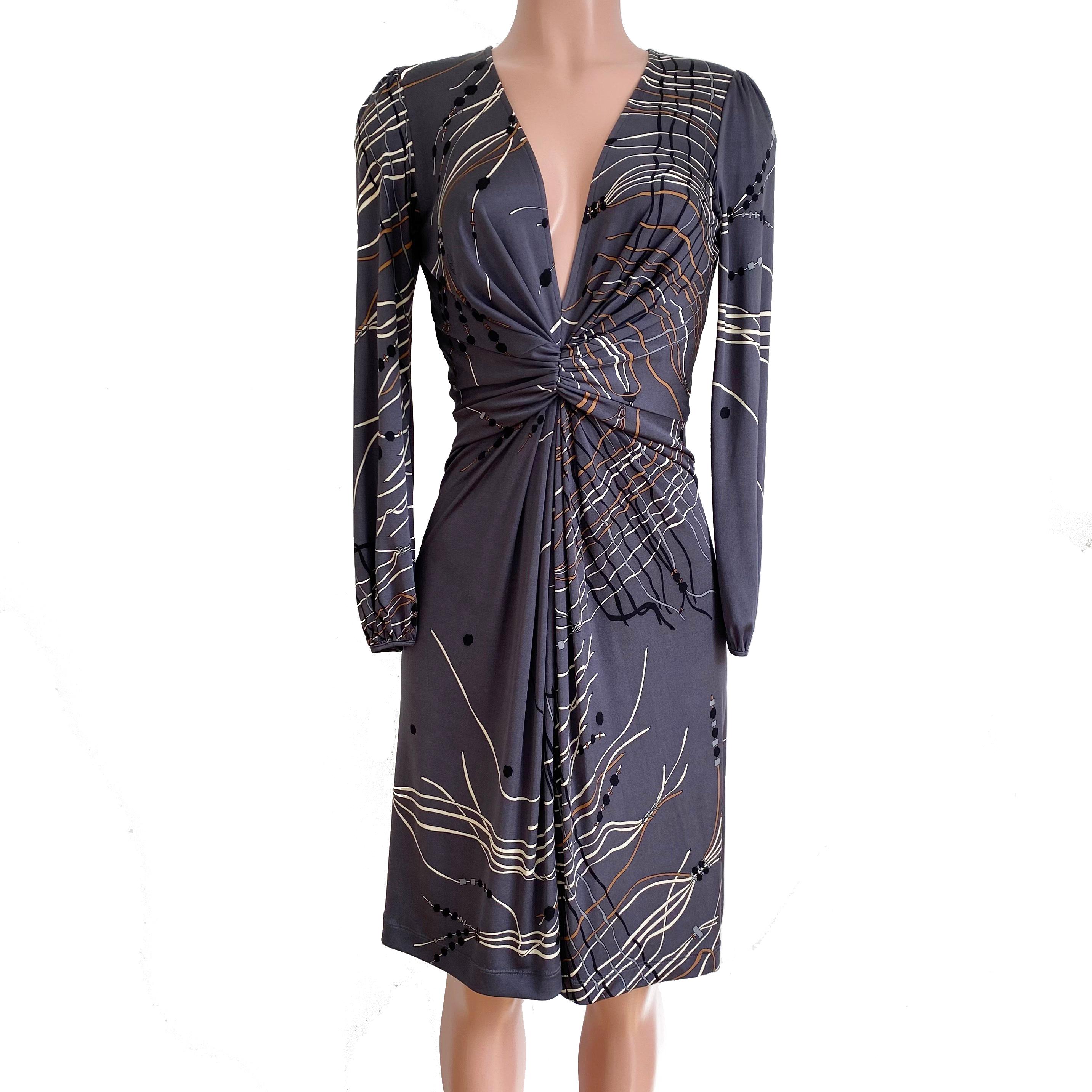 Flattering and classy dress with deep plunge V-neck. 
In original Japanese tassel print on gray,
Invisible back zipper for easy entry, slightly flared skirt with hidden pleat at front.
Approximately 40.5