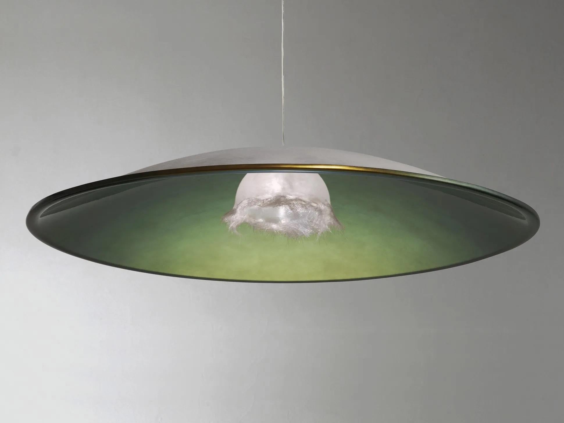 Flora pendant lamp by Imperfettolab
2011
Designer : Verter Turroni
Dimensions: Ø 187 x 32 cm
Materials: Fibreglass
Also available in white.

A suspension lamp that hides a gem around the source of its light. A finely crafted fiberglass