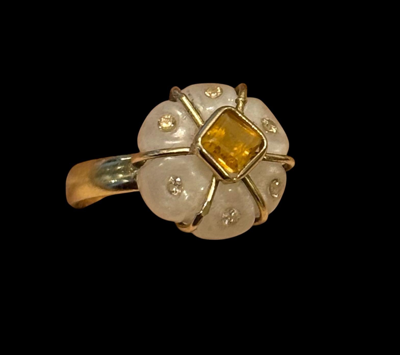 FLORA  Ring

Moonstone, Citrine, Diamonds, 14k Gold

Carved white moonstone flower (15mm diameter) with center square citrine bezeled in 14k gold surrounded by eight 1.5mm champagne diamonds on a 3mm thick 14k gold band. 

This lovely FLORA ring Is