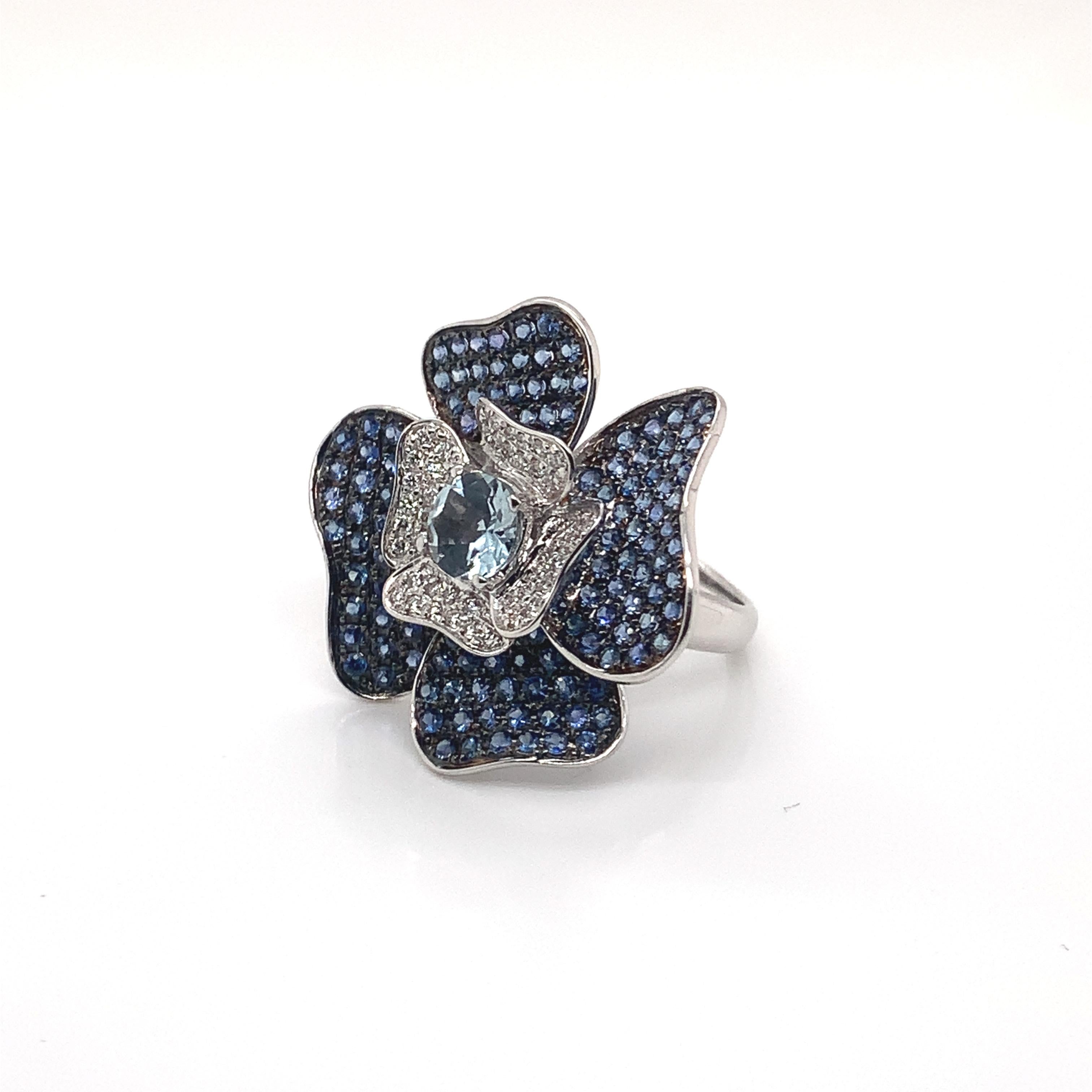 Glamorous Gemstones - Sunita Nahata started off her career as a gemstone trader, and this particular collection reflects her love for multi-colored semi-precious gemstones. This ring presents a floral aquamarine center with blue sapphire petals.