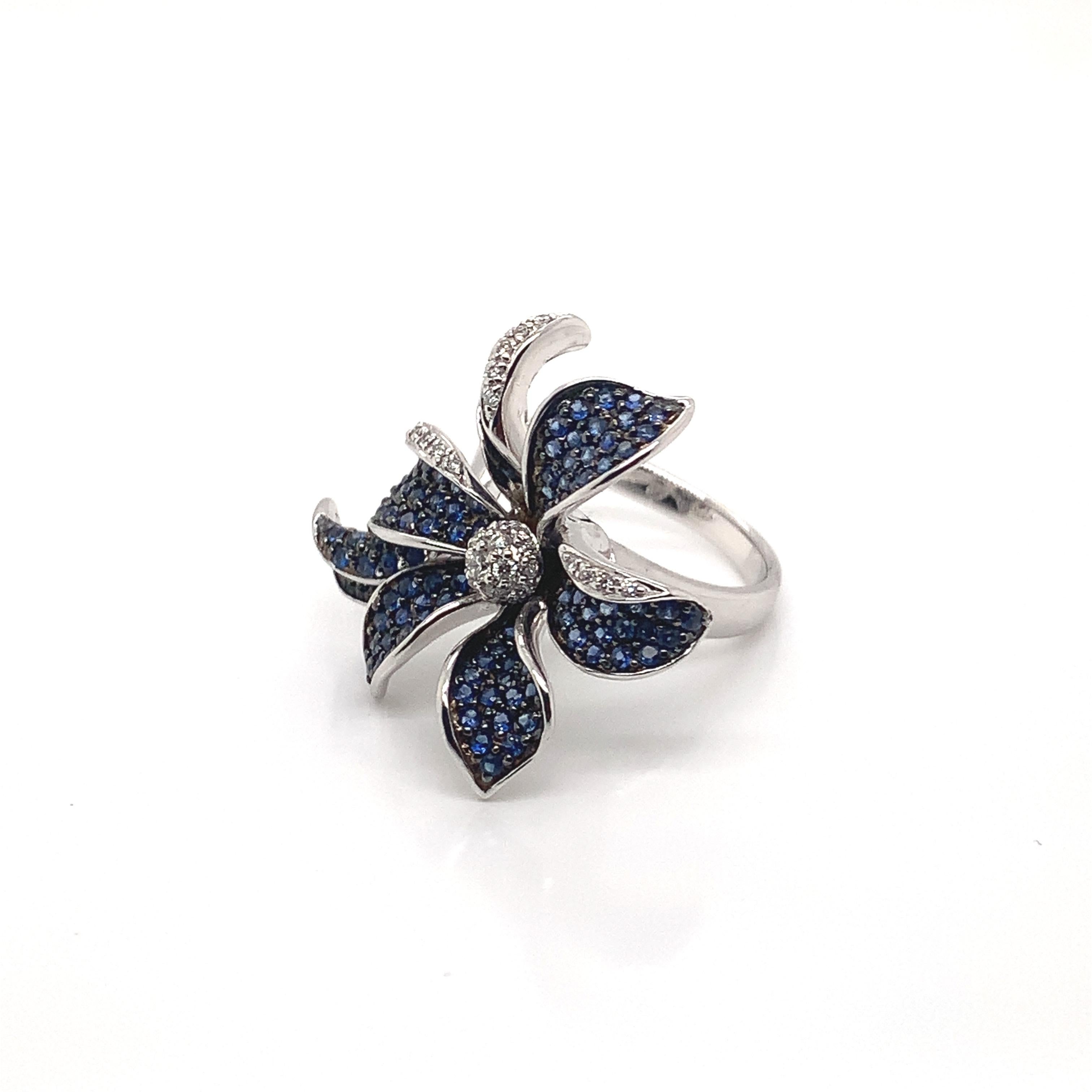 Glamorous Gemstones - Sunita Nahata started off her career as a gemstone trader, and this particular collection reflects her love for multi-colored semi-precious gemstones. This ring presents a floral blue sapphire with white diamond detailing. 