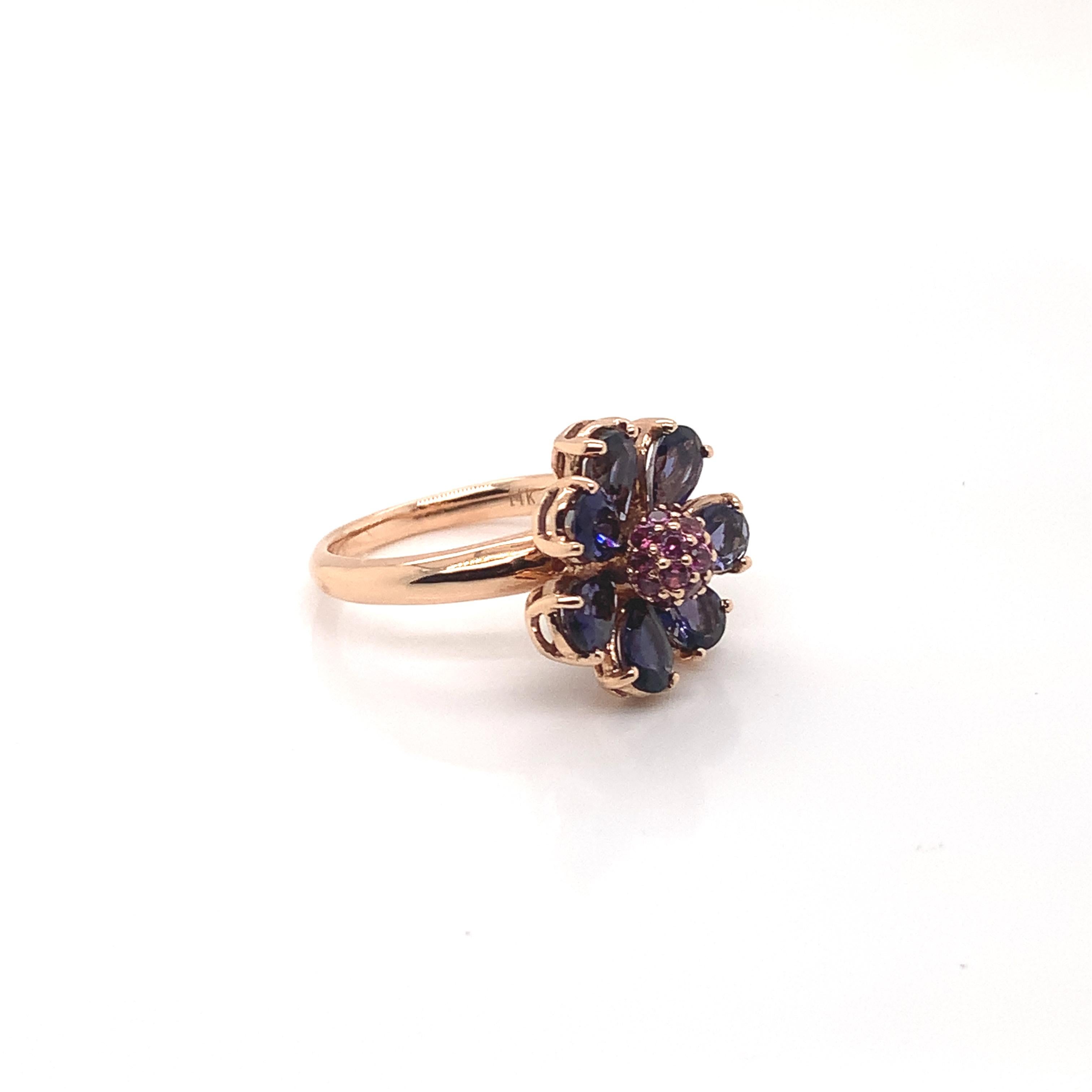 Glamorous Gemstones - Sunita Nahata started off her career as a gemstone trader, and this particular collection reflects her love for multi-colored semi-precious gemstones. This ring presents a floral iolite set around a cluster of rhodolite