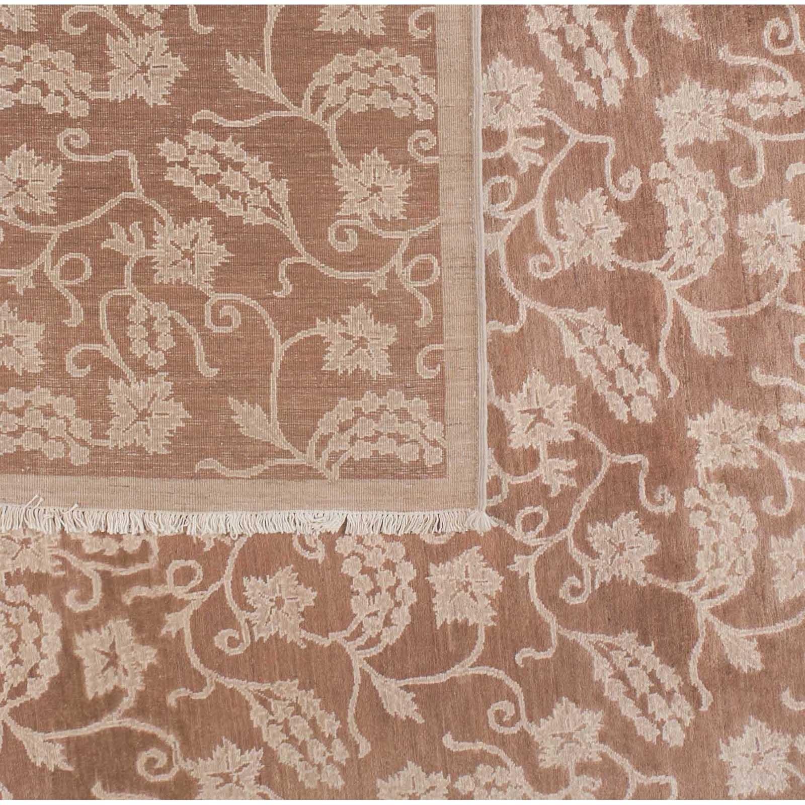 Flowers, leaves and vines in beige stand out against a warm brown background in this variation on a popular Pakistani design. Hand knotted in wool using vegetal dyes.