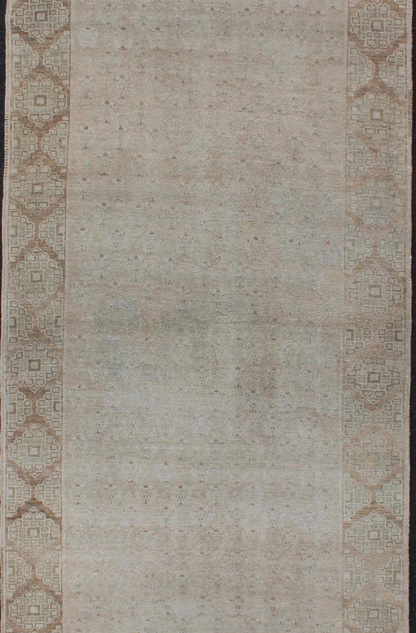 Floral All-Over Medallion Vintage Turkish Oushak Runner with Faded Color Palette In Good Condition For Sale In Atlanta, GA