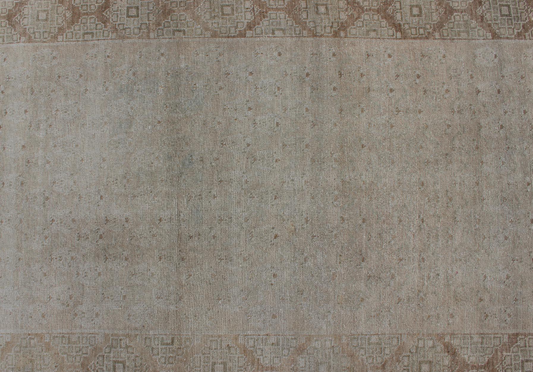 Wool Floral All-Over Medallion Vintage Turkish Oushak Runner with Faded Color Palette For Sale