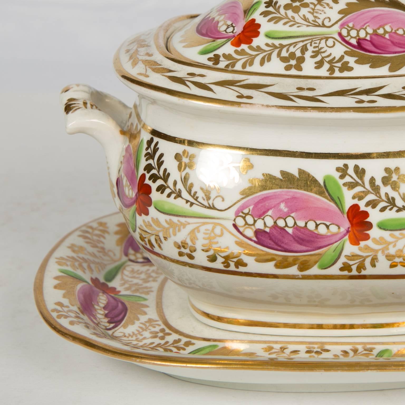 We are pleased to offer this charming English porcelain sugar box with stand. The colors are a vibrant raspberry and spring green with gilded leaves, made circa 1830.
 