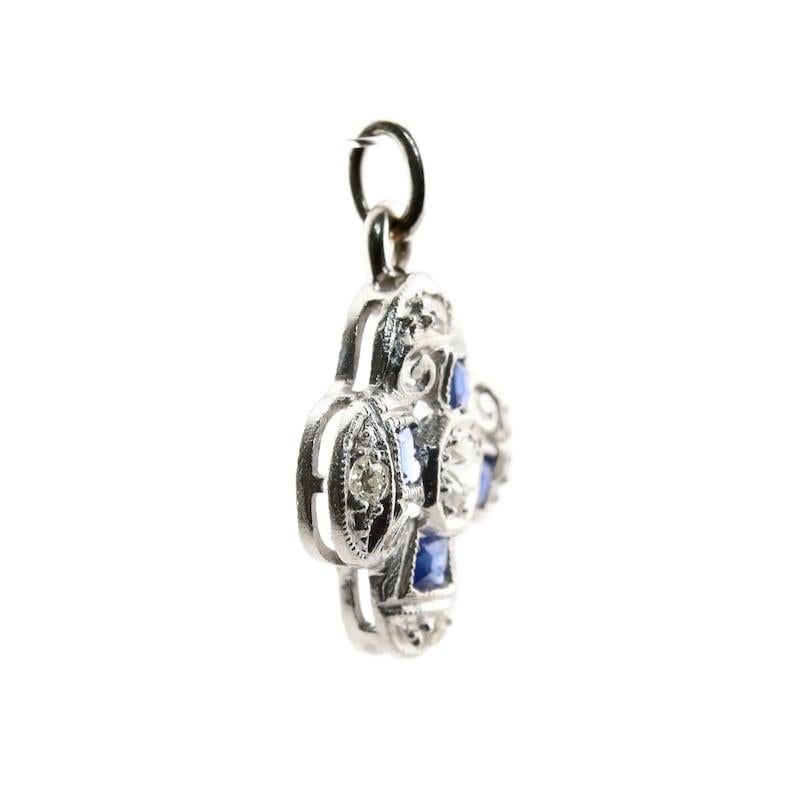 Aston Estate Jewelry Presents:

An Art Deco diamond and sapphire charm in the form of a flower. Set with 0.14 carats of old European cut diamonds. Accented by four bright blue step cut sapphires.

Tested as Platinum.

Measurements: 1/2