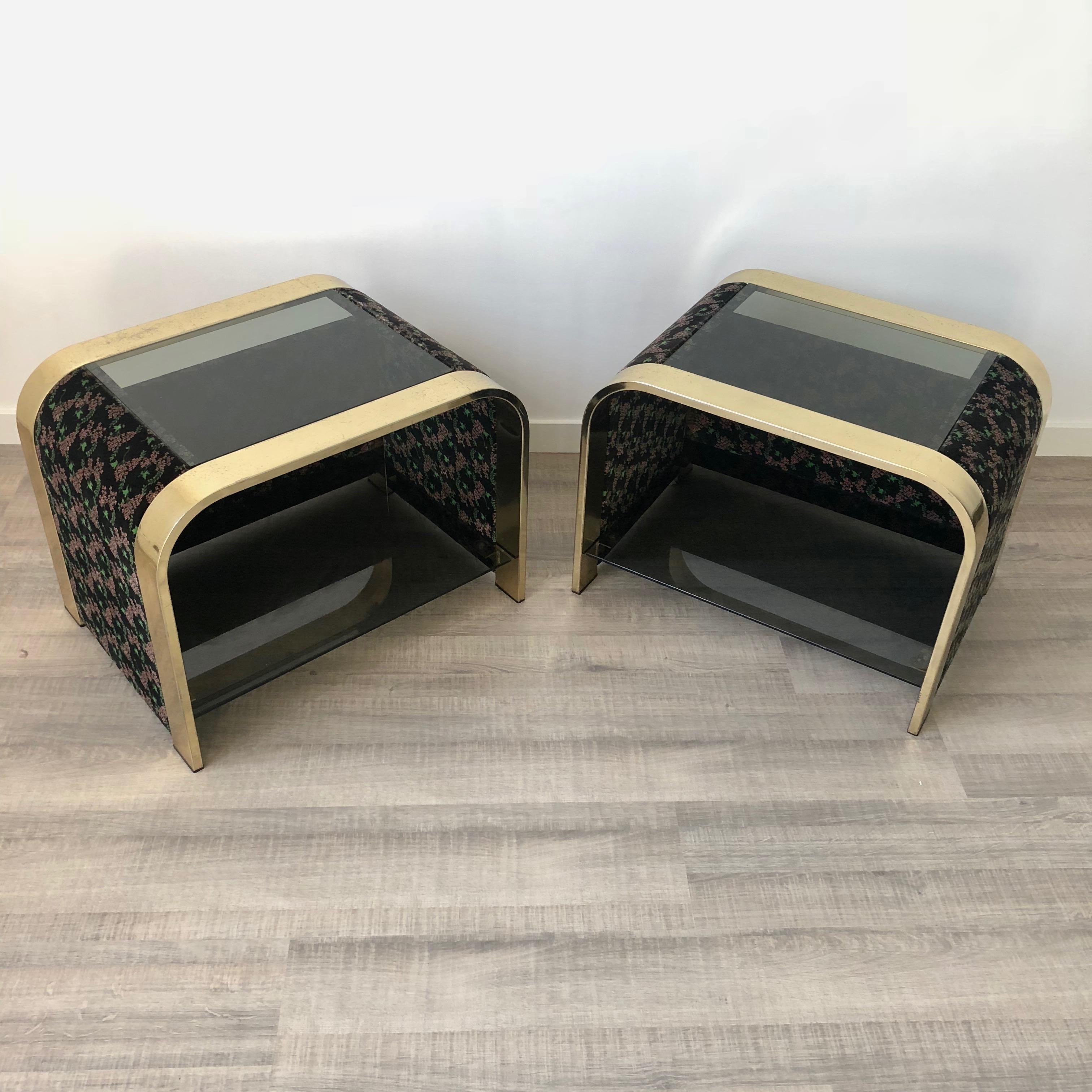 Pair of rare Italian beside or end table made of brass, velvet and dark glass attributed to Romeo Rega. They are opened on one side and the theme of the velvet is floral (pink mimosa flowers with one green leaf).
 