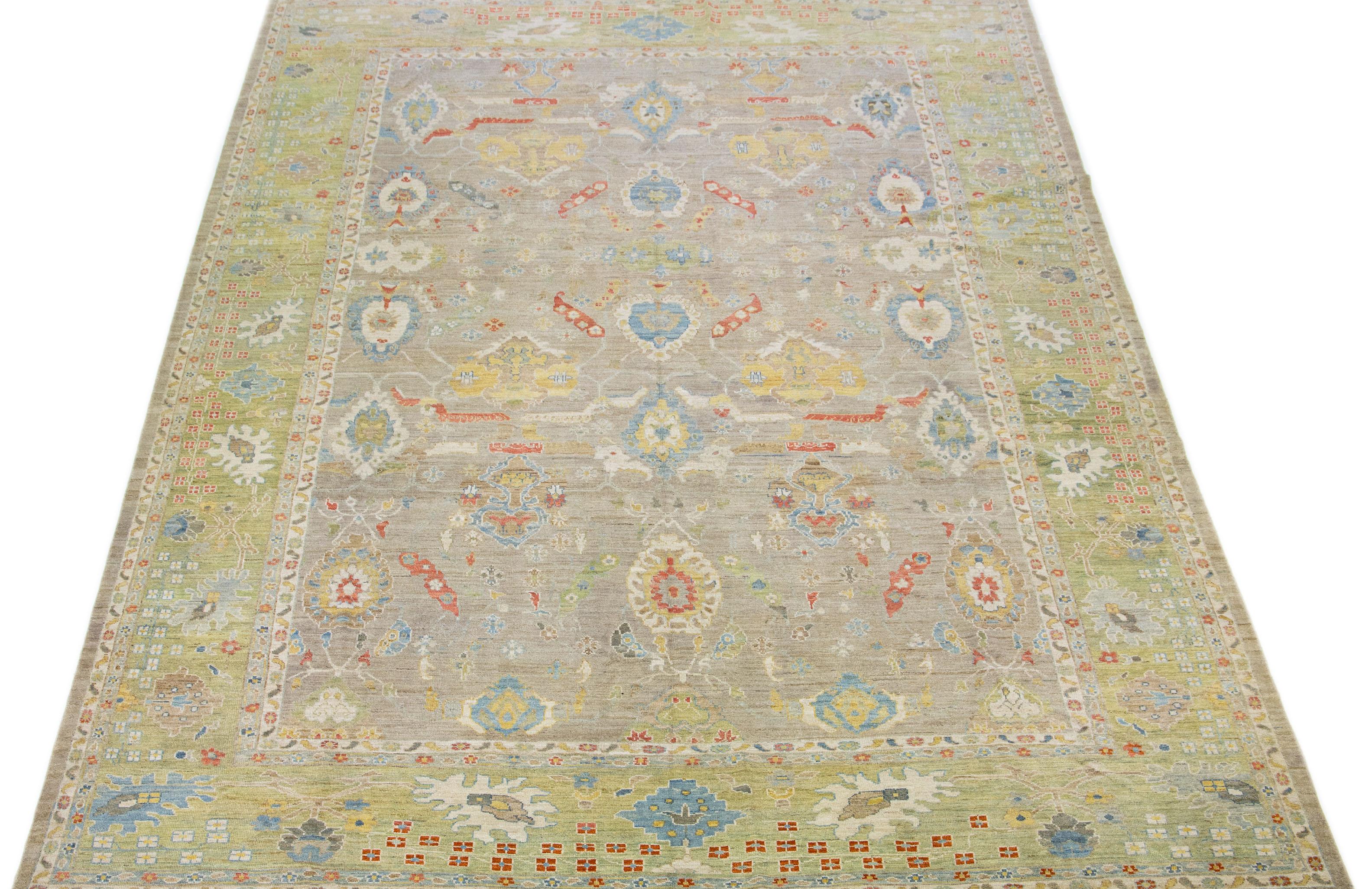 This contemporary take on the traditional Sultanabad style is showcased in an exquisite hand-knotted wool rug with a striking beige color. An intricately designed frame accentuates its all-over floral motif, adorned with multicolored accents that