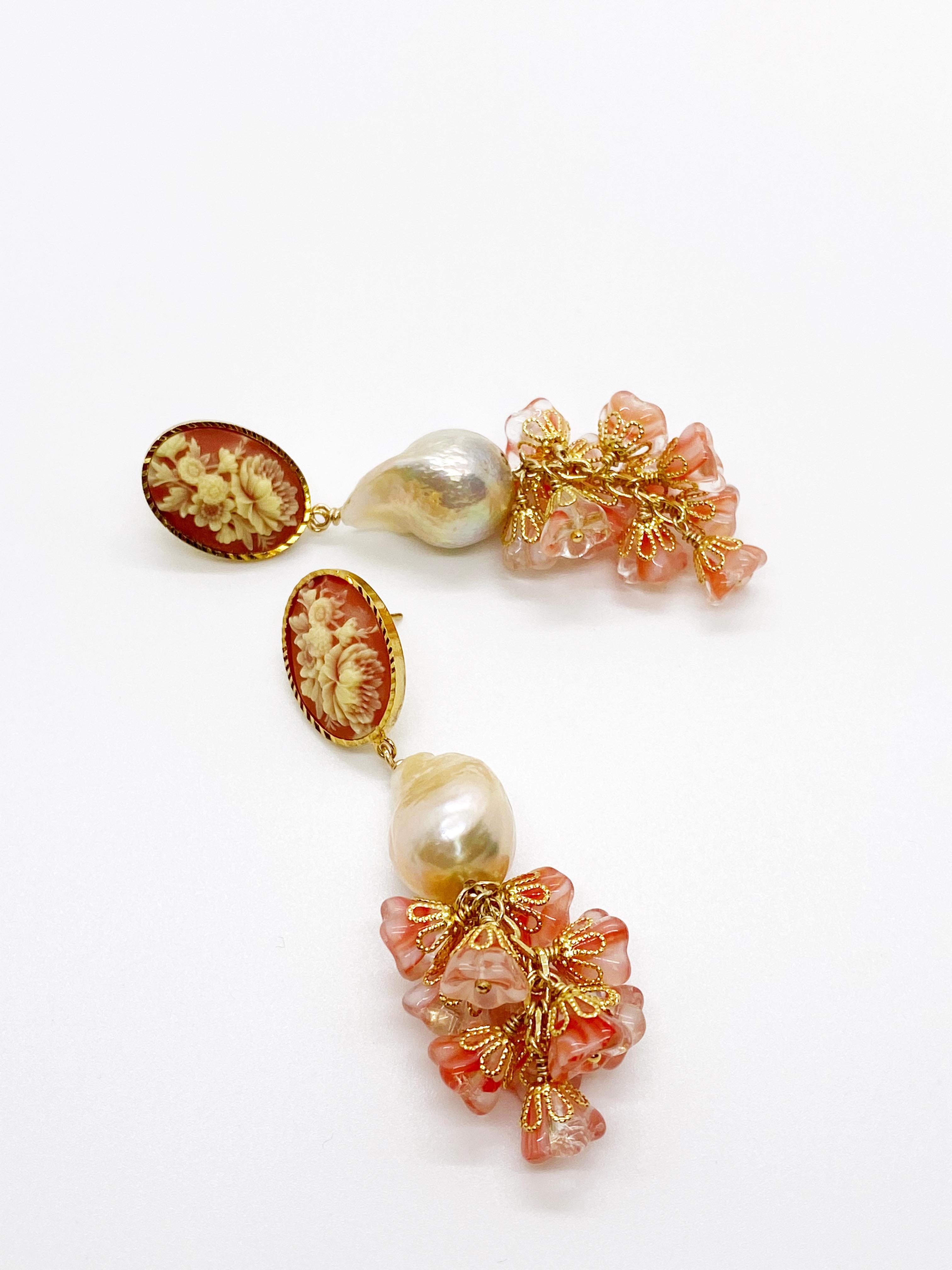 The earrings consist of a vintage Western Germany cabochon with ivory floral relief that is rich with texture. 
The cabochon is set on 24K gold-plated setting. A natural baroque pearl hangs on the cabochon with 10 Czech glass floral bells that