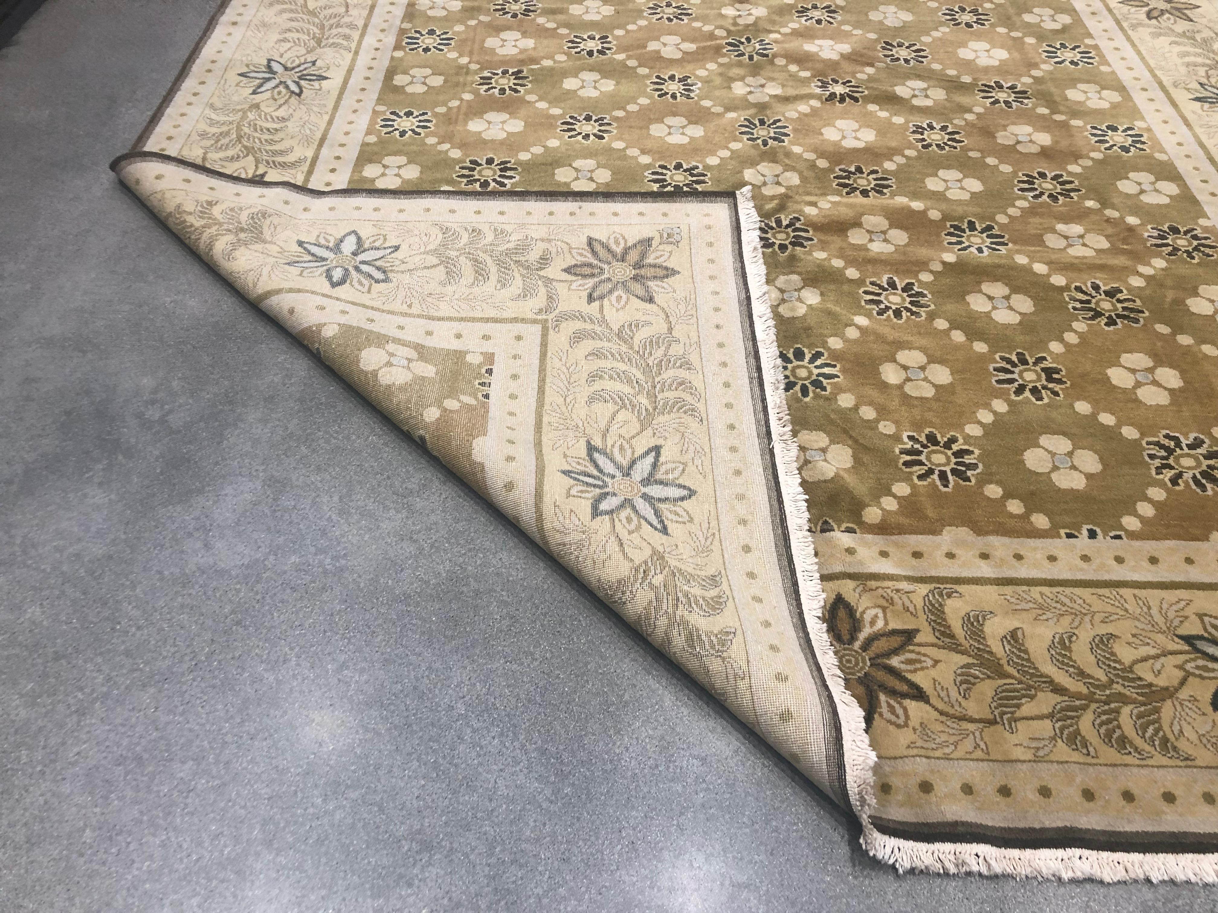 Traditional and modern styles come together in a creative way in this charming area rug. Colorful blossoms burst from the beige border that surrounds a golden core. The stylized floral grid with black and beige creates a tile-like look in the plush