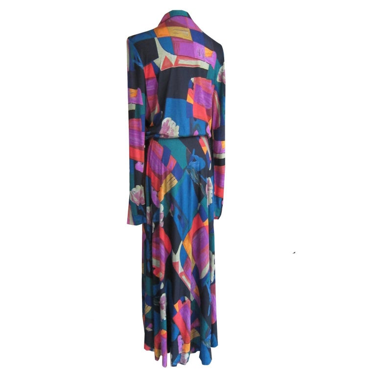 Elegant multi colour blue green base floral prints bias cut maxi dress from 1970s. Unlined with golden button front closure, elastic waist with matching belt.
Long slim sleeves, Viscose, beautifully fitted dress. 
Measurements : 
Shoulder : 42