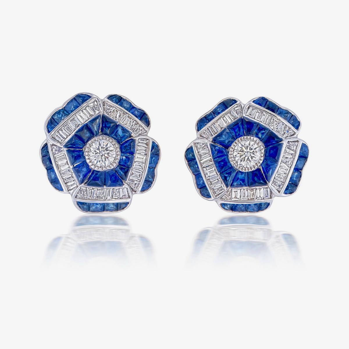 A pair of fine modern blue sapphire and diamond floral earrings made in 18 Karat gold. A great choice for lifestyle wear.
- There are two center diamonds with a total weight of 0.25 carats
- There are sixty-one tapered-baguette supporting diamonds