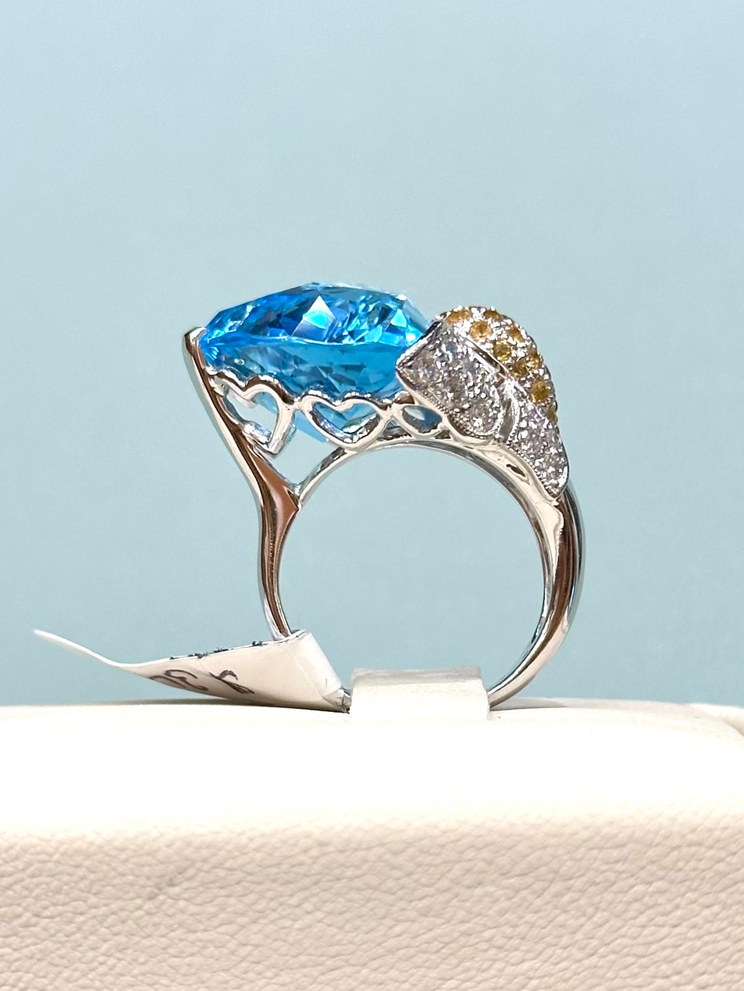 Floral Blue Topaz Ring with Diamonds and Yellow Sapphires set in 18k White Gold. 

1.02 carats of diamonds

Total weight: 12.56 grams