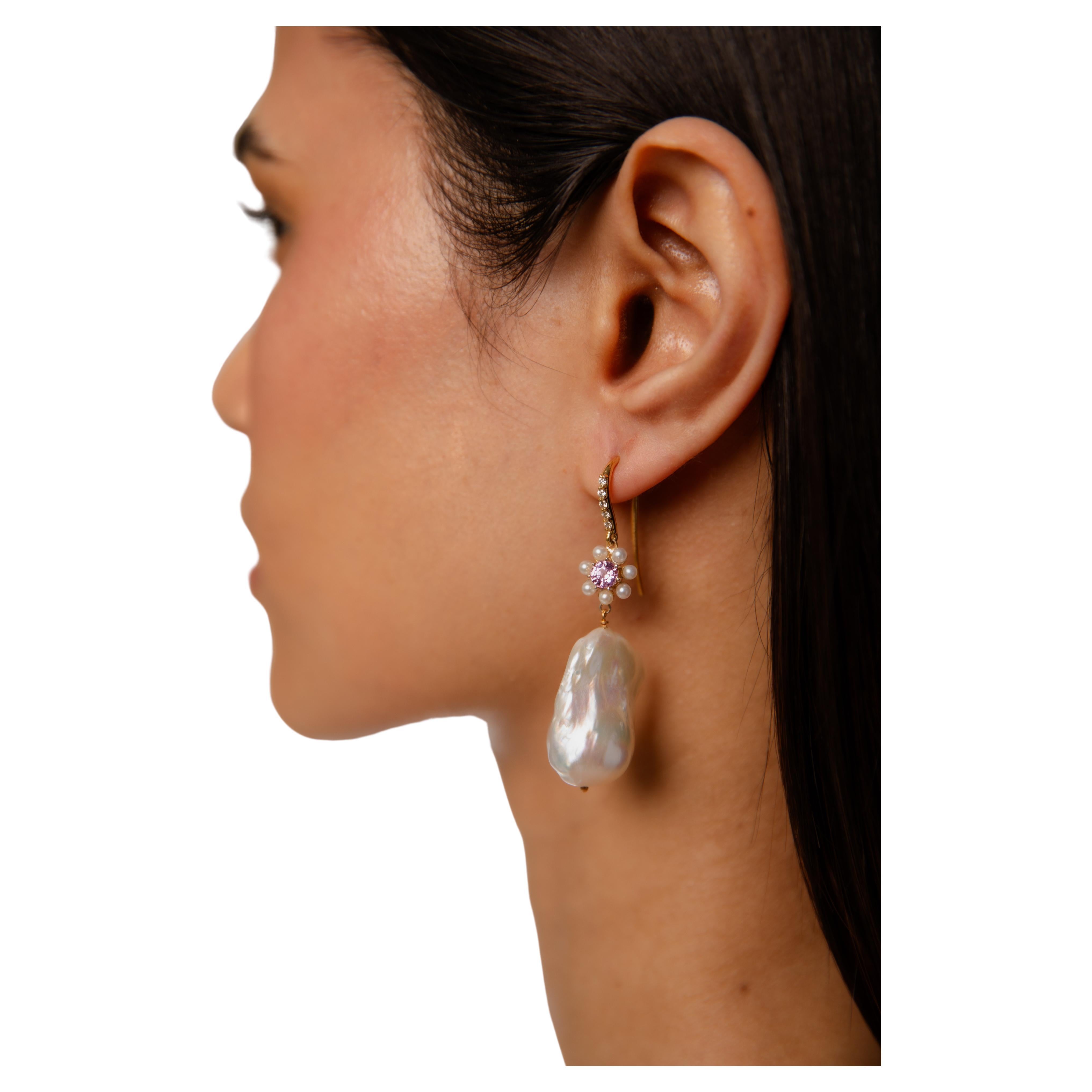 Round brilliant diamonds set in a fish hook back

10 round diamonds (pair)

Total carat weight: 0.20ct

GHSI-1 quality (natural)

5 mm round pink sapphire set in a pearl flower setting, for that delicate look

Freshwater baroque pearls