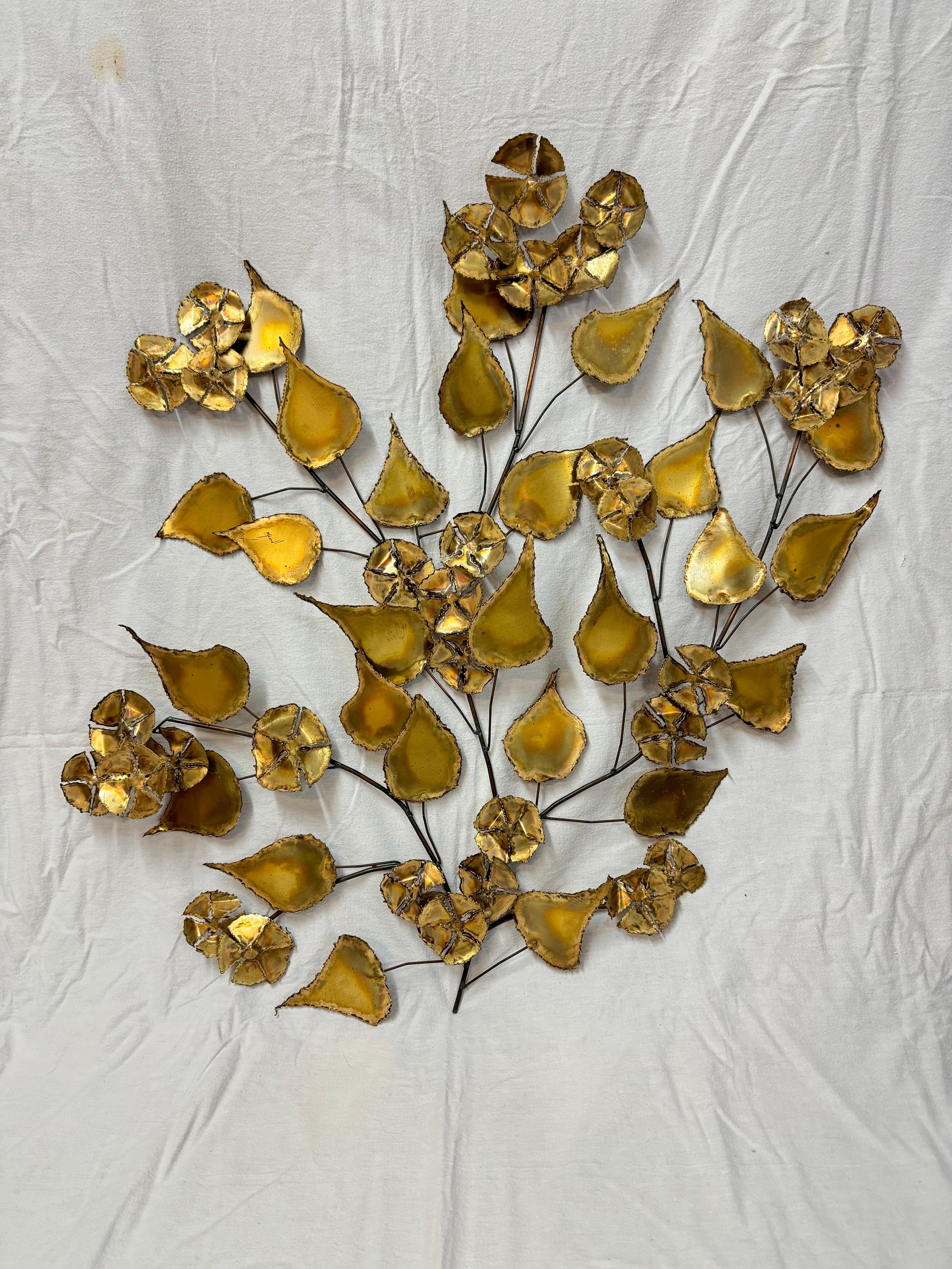 Floral Brutalist Gilt Wall Sculpture in the style of Curtis Jere. Rare and hard to find design.
Perfect accent piece for that focal point. 
