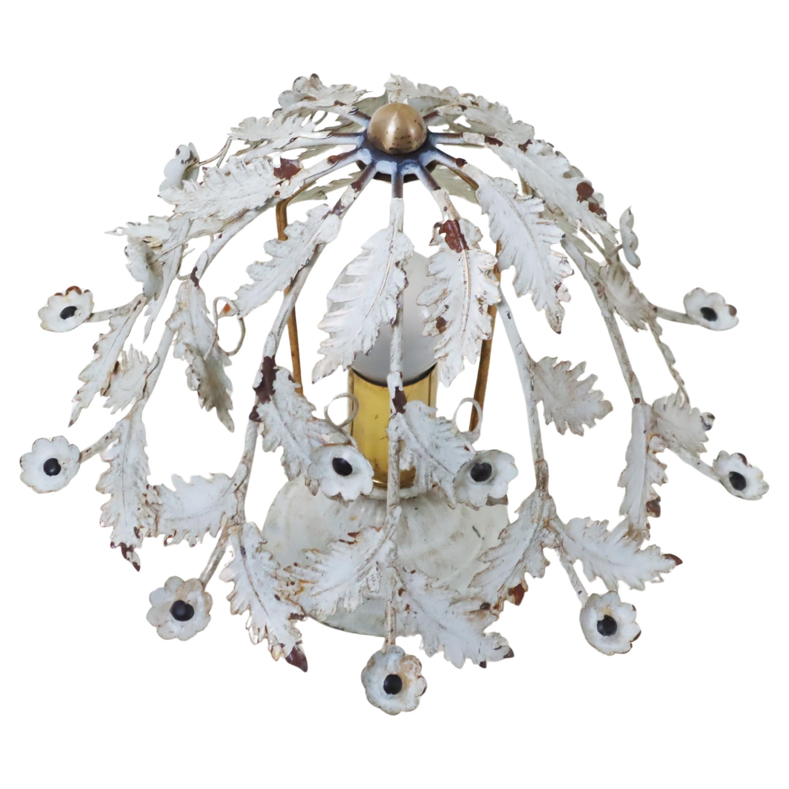 Questa piccola plafoniera è un vero incanto. Il suo invecchiamento naturale gli conferisce un tocco di eleganza. I piccoli fiori sono squisitamente lavorati e le foglie si intrecciano verso l'alto in uno splendido spettacolo dell'arte della natura.