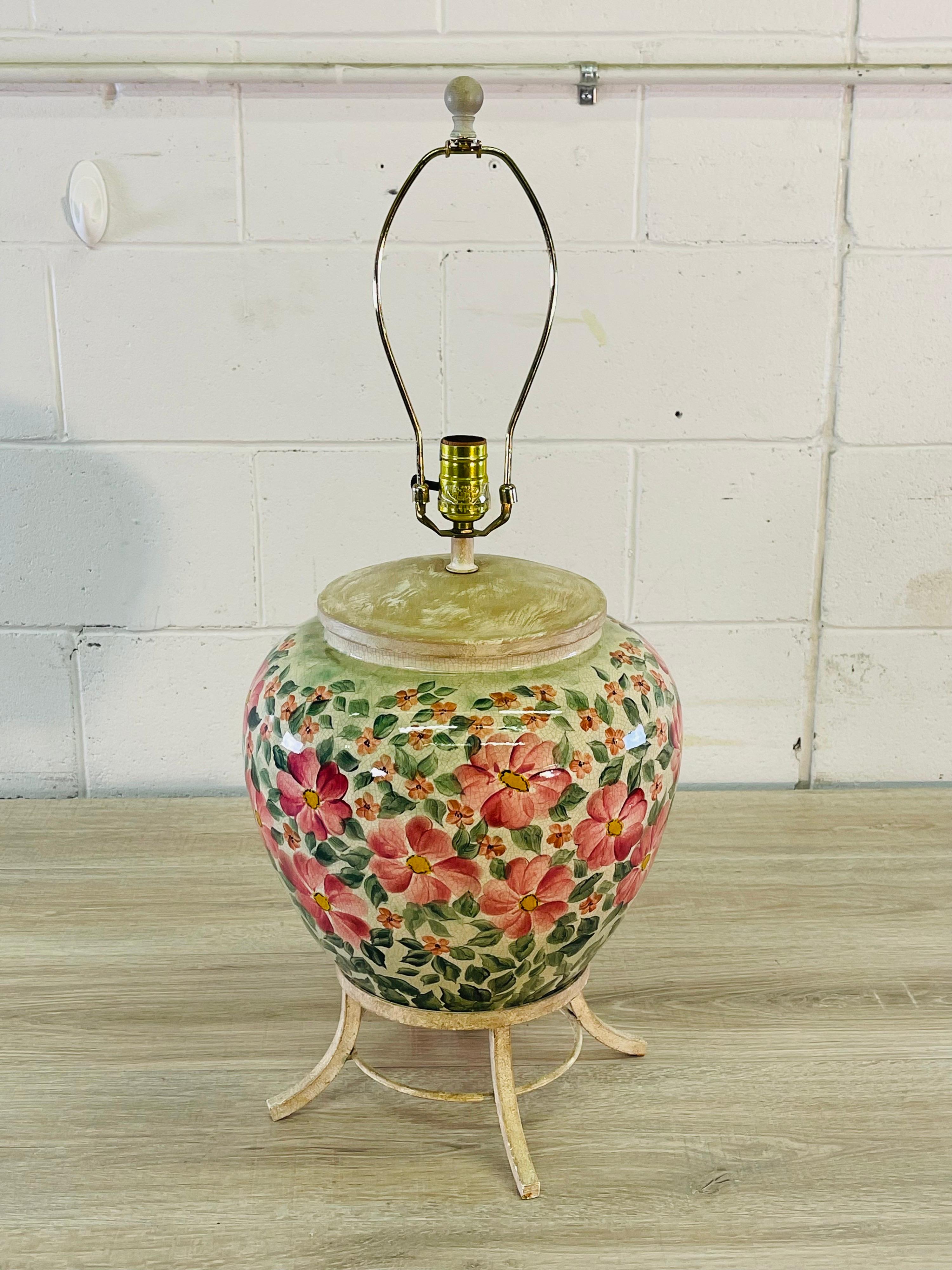 Vintage 1970s floral round ceramic table lamp with a white-washed metal base. Wired for the US and in working condition. Socket, 19” H. Harp, 5” diameter x 9” height. No marks.