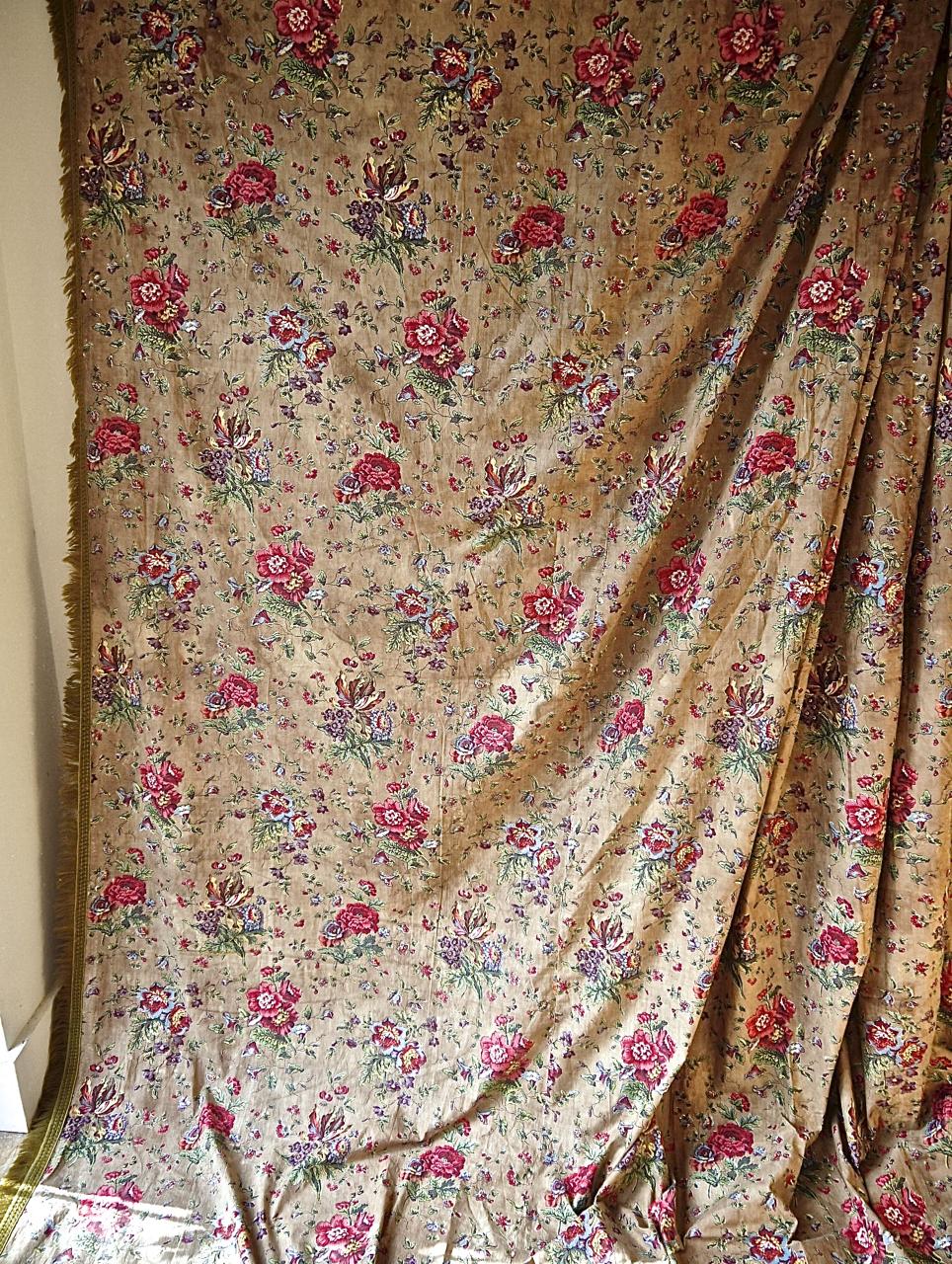 Early 19th century French single chintz curtain from a manufacturer in Alsace in eastern France that is blockprinted with joyous tulips and other flowers on a tobacco ground. Skillful printing and overprinting make for a beautiful colorful textile.