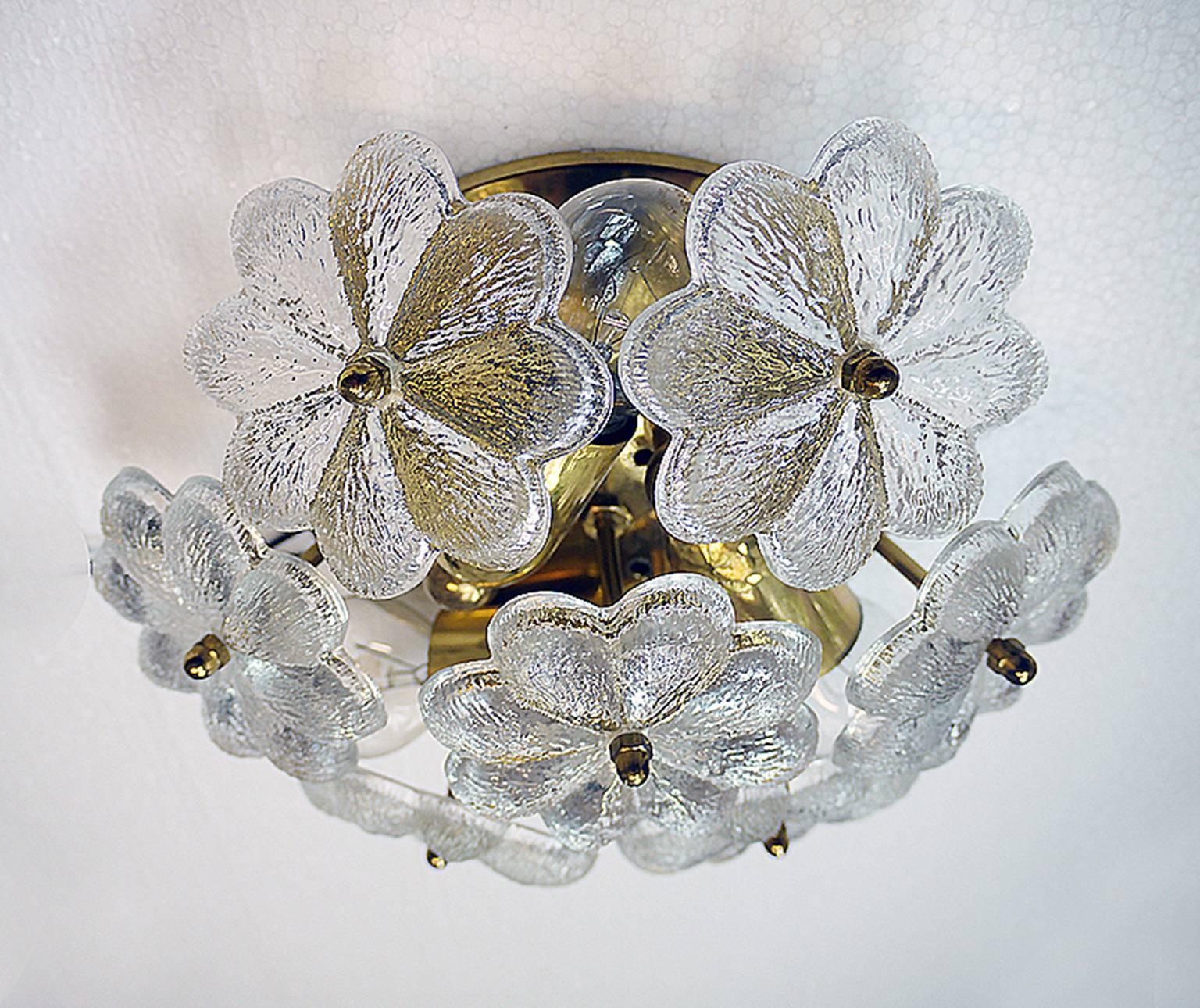 Elegant crystal flush mount and/or wall sconce with 13 overlapping clear glass flowers on a brass frame. The lamp emits smooth indirect light downwards. A real eye-catcher even unlit. Made in the 1960s by Palwa (Ernst Palme & Walter) in Germany. 
