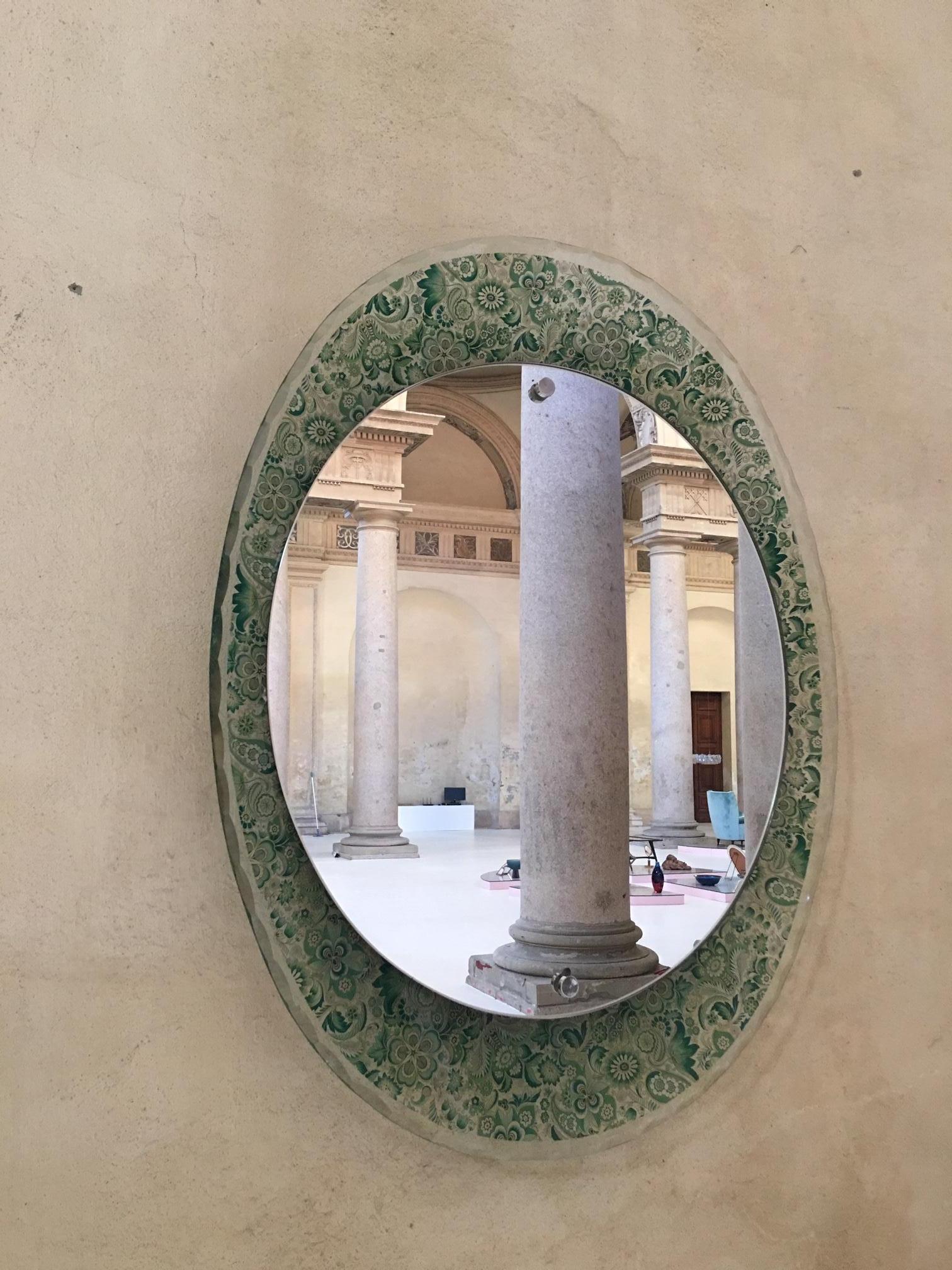 Splendid mirror with floral decorated faced glass frame.