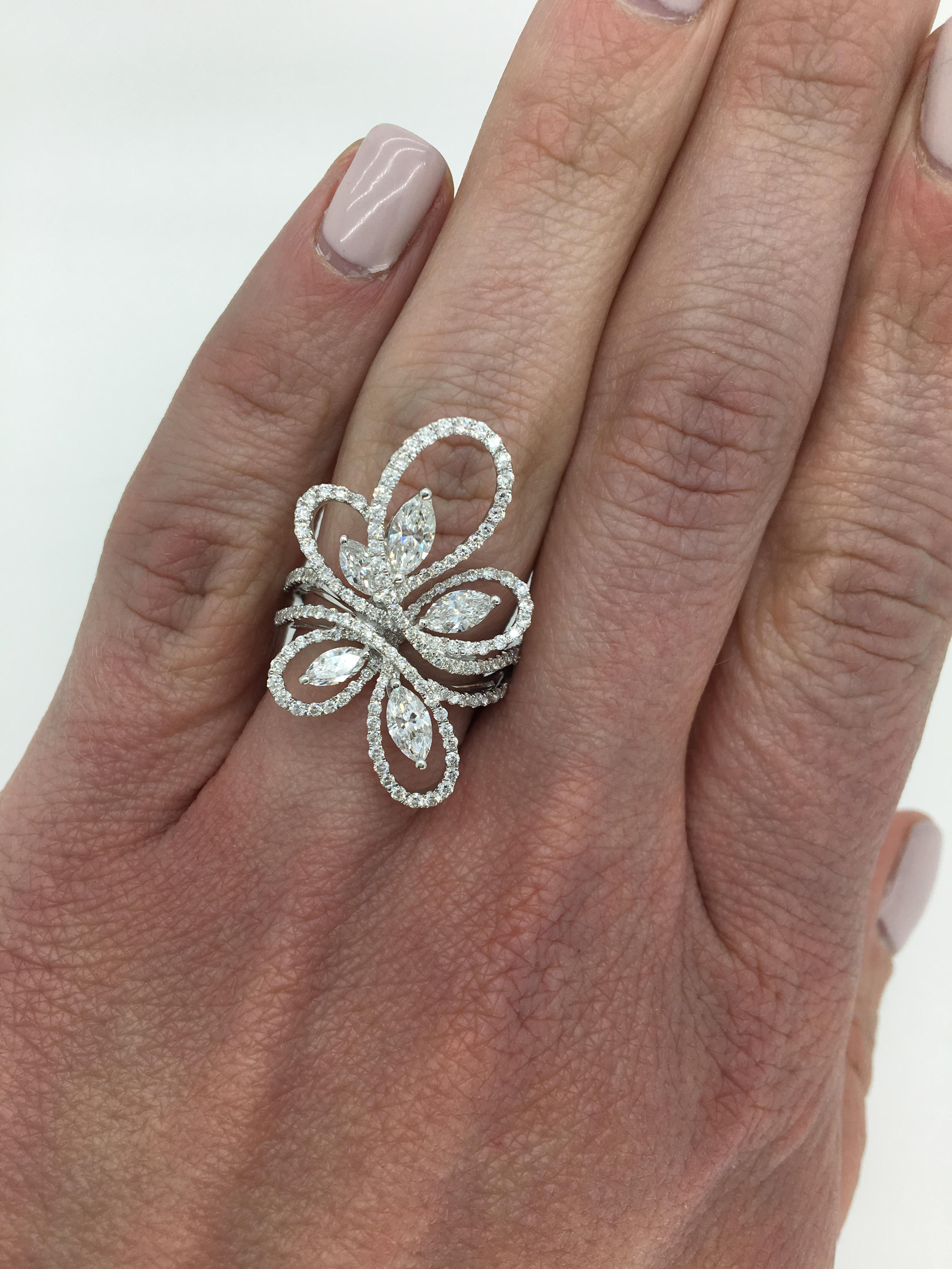 Pave set diamond ring with a floral swirl of Round Brilliant Cut and Marquise Cut diamonds crafted in 18k white gold.

Diamond Cut: Marquise Cut and Round Brilliant Cut
Average Diamond Color: G-H
Average Diamond Clarity:  VS-SI
Diamond Carat Weight: