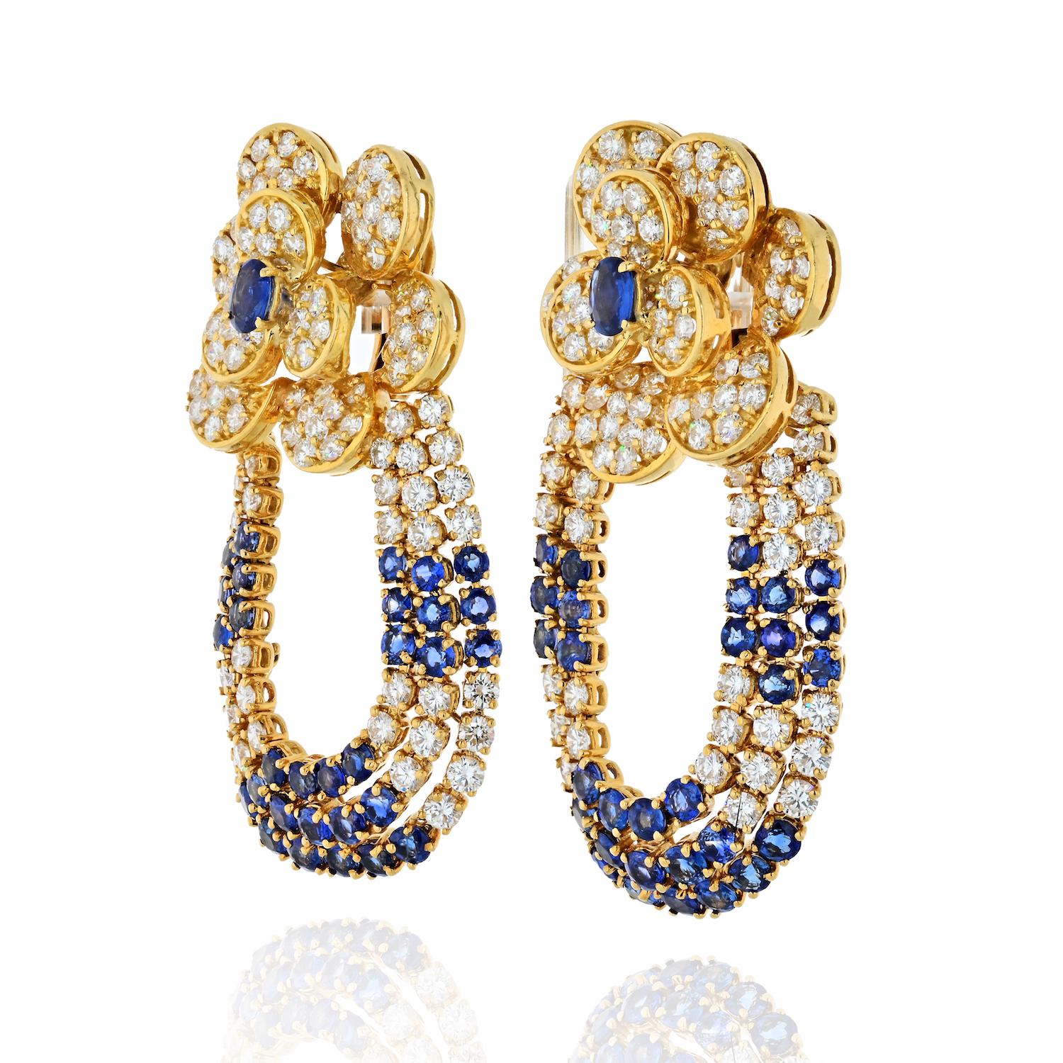 Make a strong impression wearing these large sapphire and diamond flower top earrings. Crafted in 18K yellow gold featuring blue sapphires and round diamonds these earrings are for someone who is comfortable with being the center of attention.