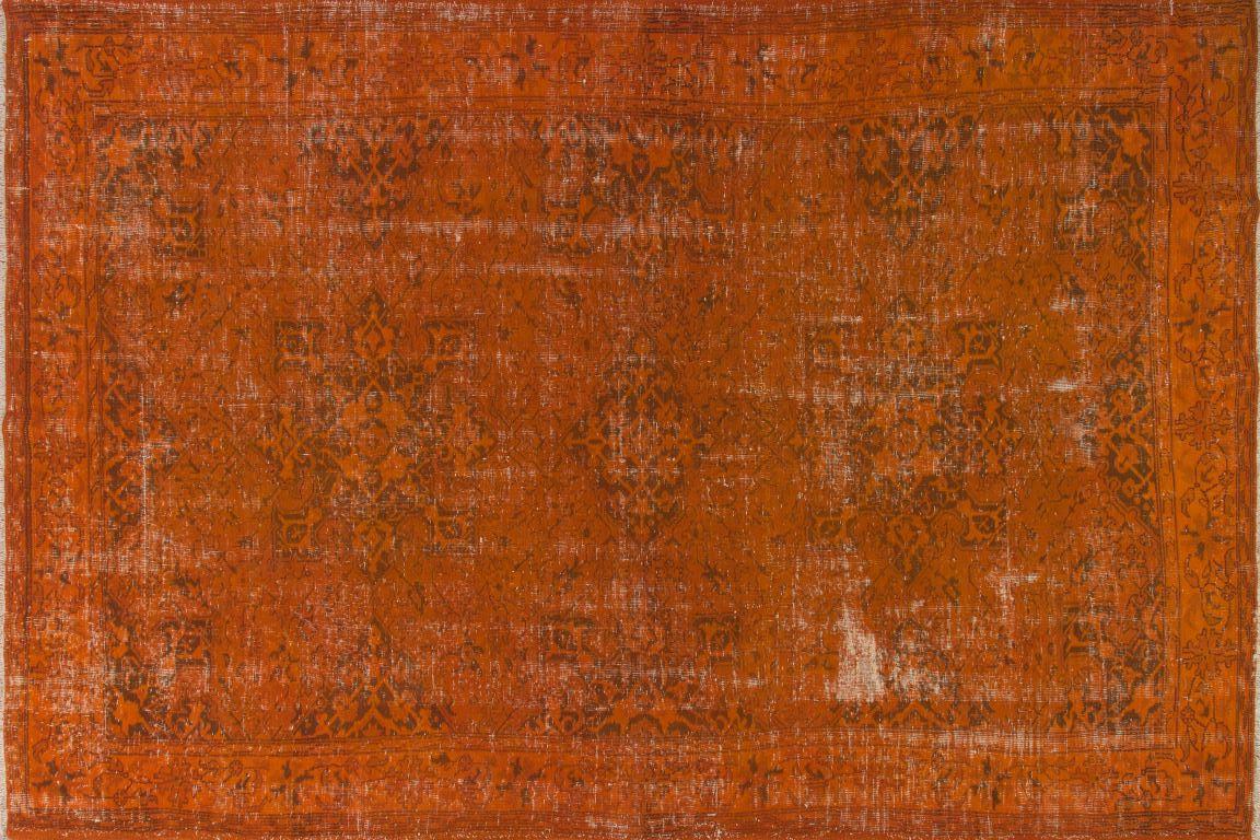 A large vintage hand-made Turkish rug over-dyed in dark orange with a design of multiple full and half medallions.  It is finely hand knotted with low wool pile on cotton foundation, in very good condition, sturdy, professionally cleaned and