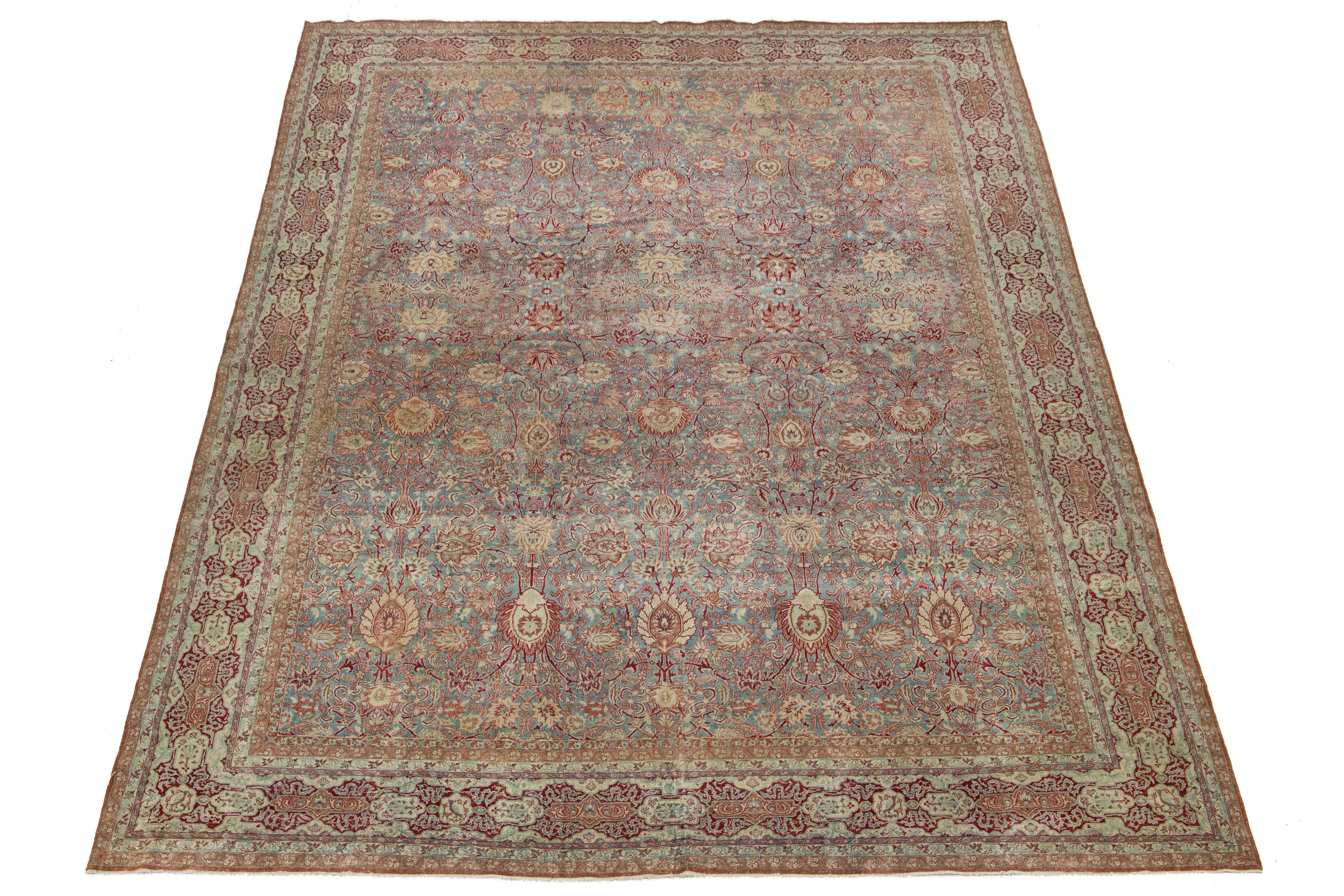 Explore the sophistication of this antique Malayer hand-knotted wool rug, featuring a deep blue field complemented by an exquisite all-over pattern enhanced by accents of red and beige. 

This rug measures 12'8