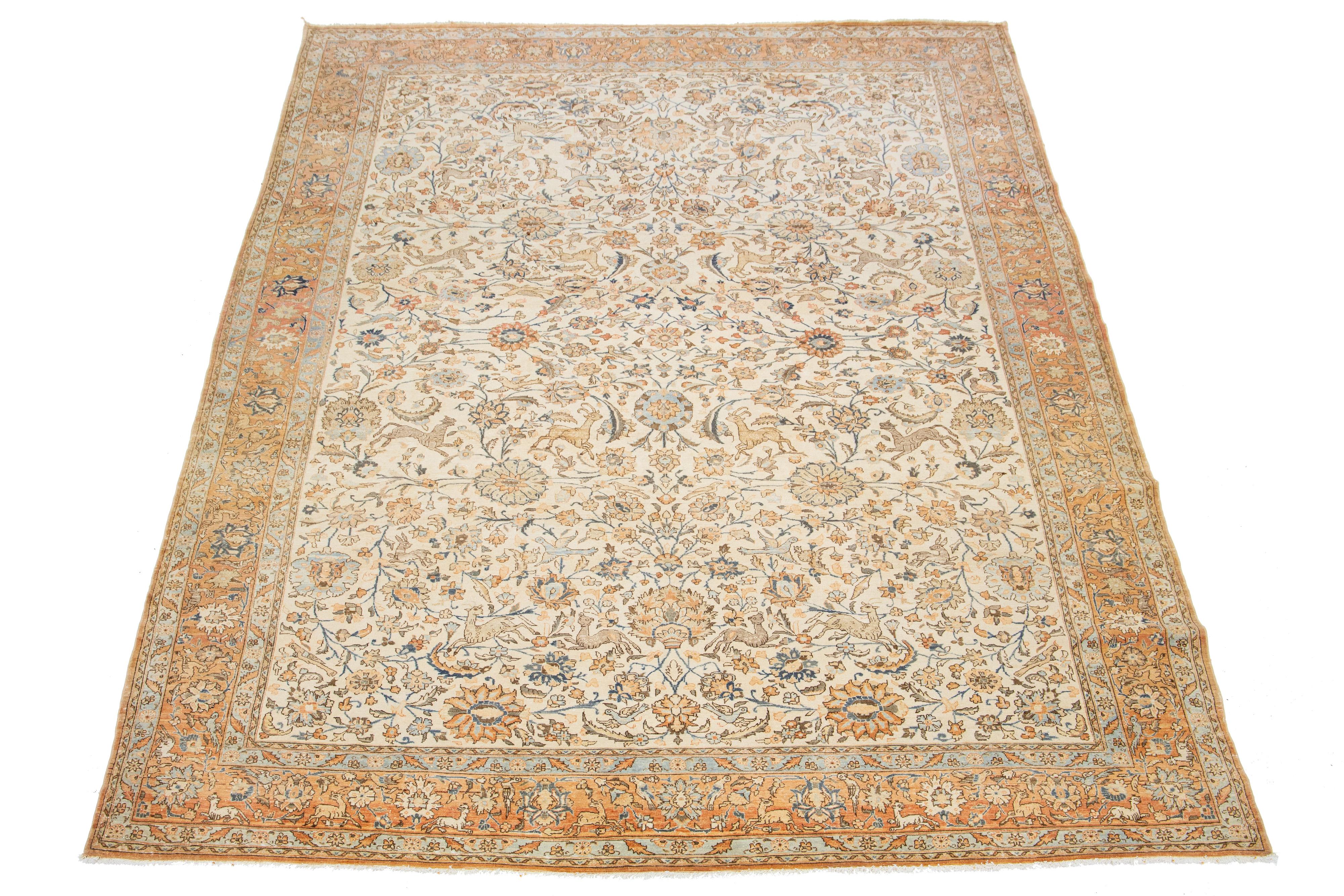 This Persian Tabriz wool rug, handcrafted, showcases a traditional floral pattern. The contrast between the beige backdrop emphasizes the orange and blue floral design.

This rug measures 8'9