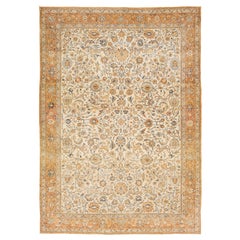 Tapis persan antique Tabriz en laine beige et orange à motifs floraux