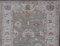 Floral Designed Oushak with Muted Background with Earthy Tones and Soft Blue